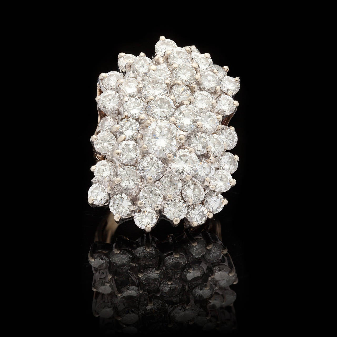 Estate Ring Features 47 Round Brilliant Cut Diamonds in a Multidimensional Cluster Measuring 32.5mm x 24.0mm. The ring is a size 6.5 with a total weight of 19.8 grams.