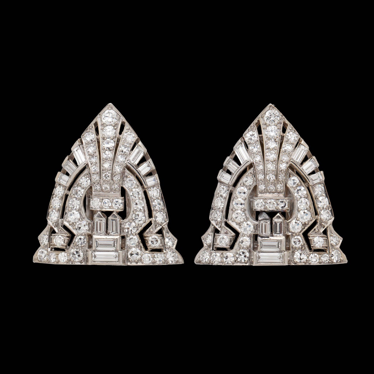 A Pair of Beautifully Crafted Clip Brooches Featuring 3.50cts of Single Cut, Baguette and Tapered Baguette Diamonds Set in 14Kt White Gold. The clips measure 26.5mm by 24.5mm and total 12.4 grams.