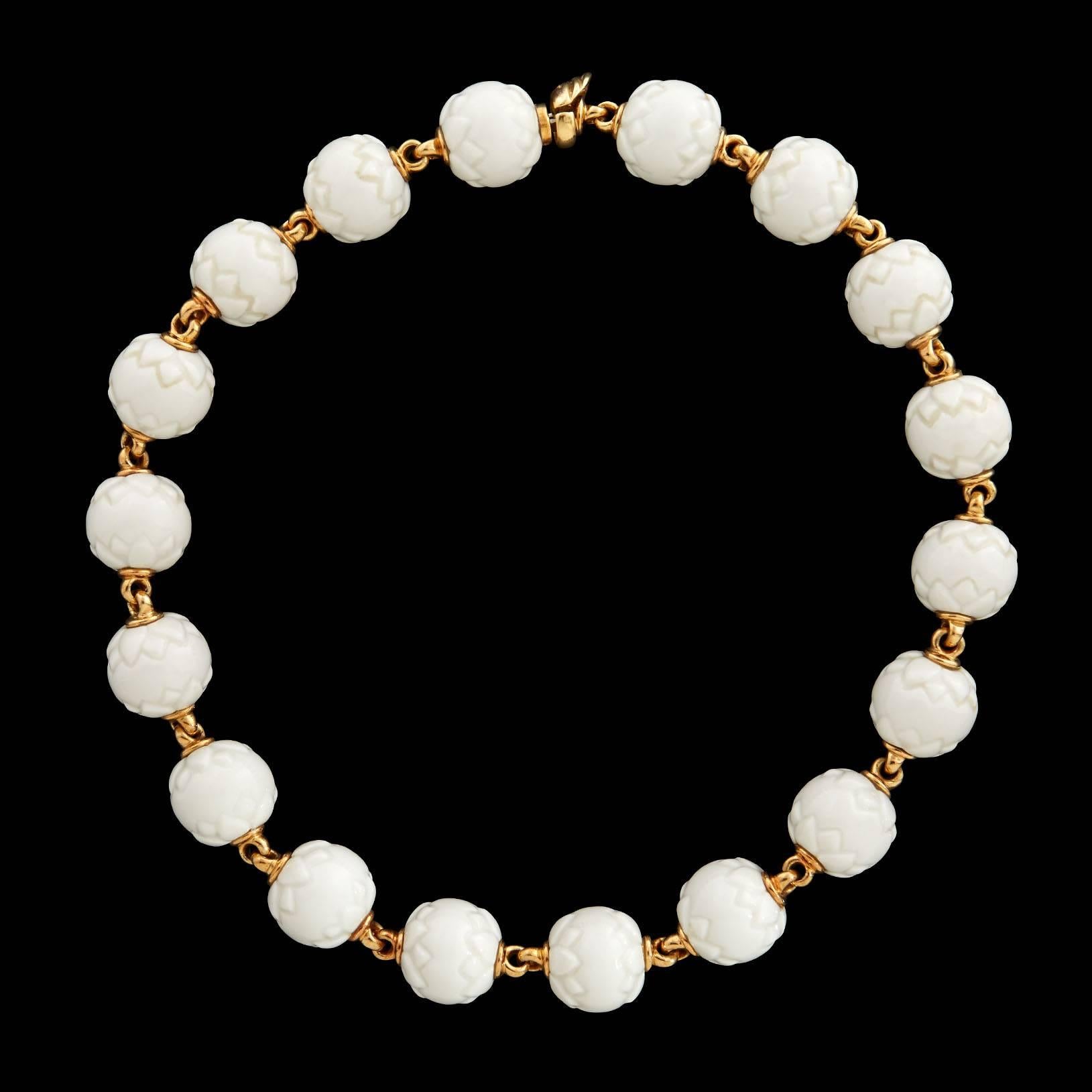 Bulgari Porcelain and 18Kt Yellow Gold Necklace from the Chandra Collection. This piece measures approximately 16.5 inches long and each bead has a 16.5mm diameter. The total weight is 113.6 grams.