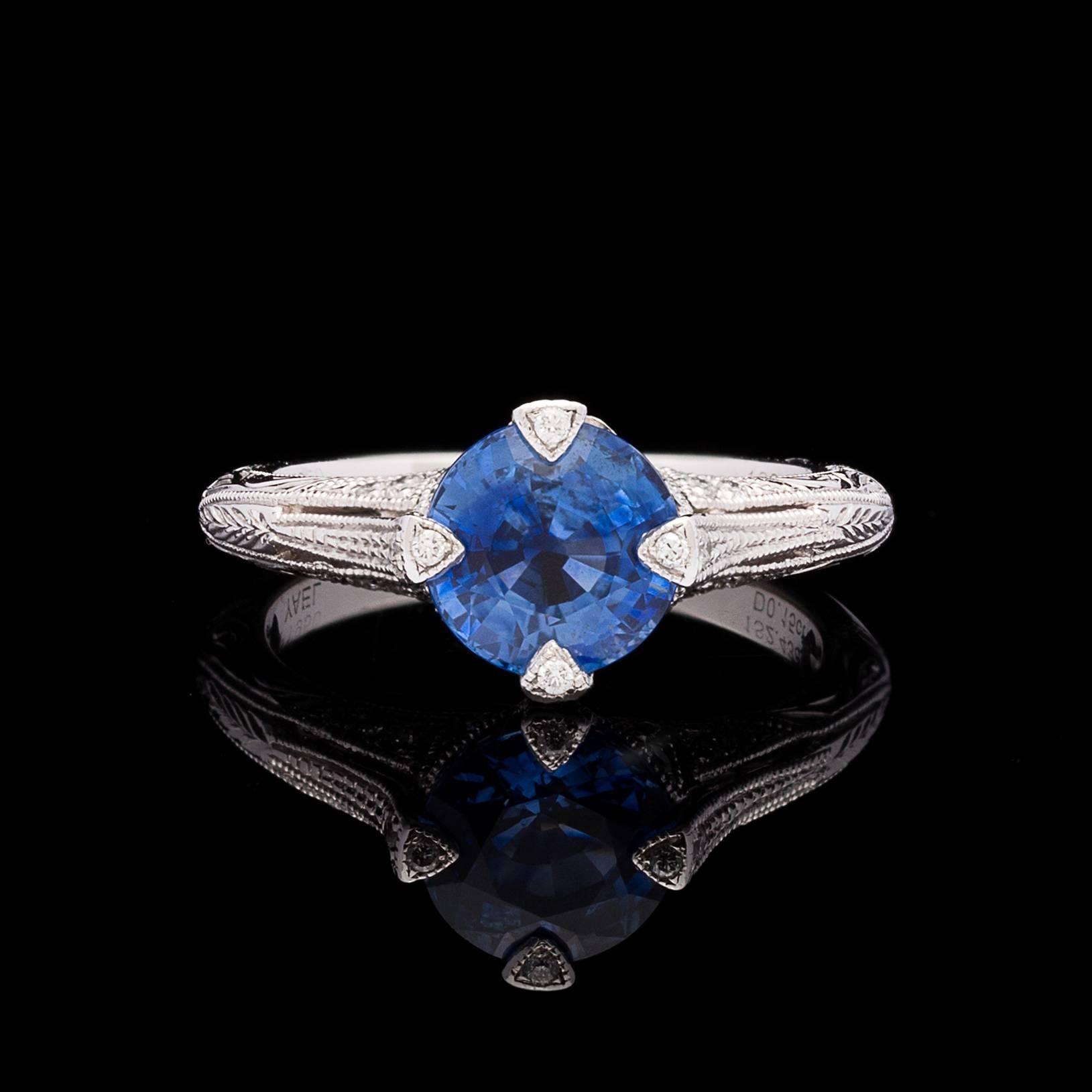 Natural Royal Blue Ceylon Round Mixed Cut Sapphire Set in a Platinum Setting Recreated from a Vintage Design Discovered in one of America’s Top Antique Jewelry Stores.  The 2.43 carat stone is prong set with milgrain detail and adorned with 24 round