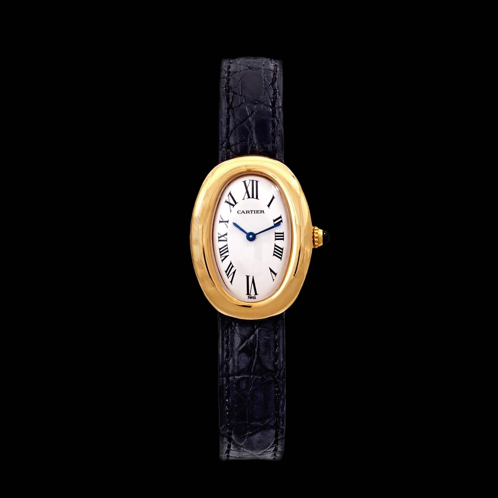 Cartier 18Kt Yellow Gold Baignoire Watch on a Caiman Leather strap with a Deployant Buckle. Small size model measuring 31.6 mm x 24.5 mm and features a sapphire cabochon on the crown of watch. The watch weighs 35.9 grams total.