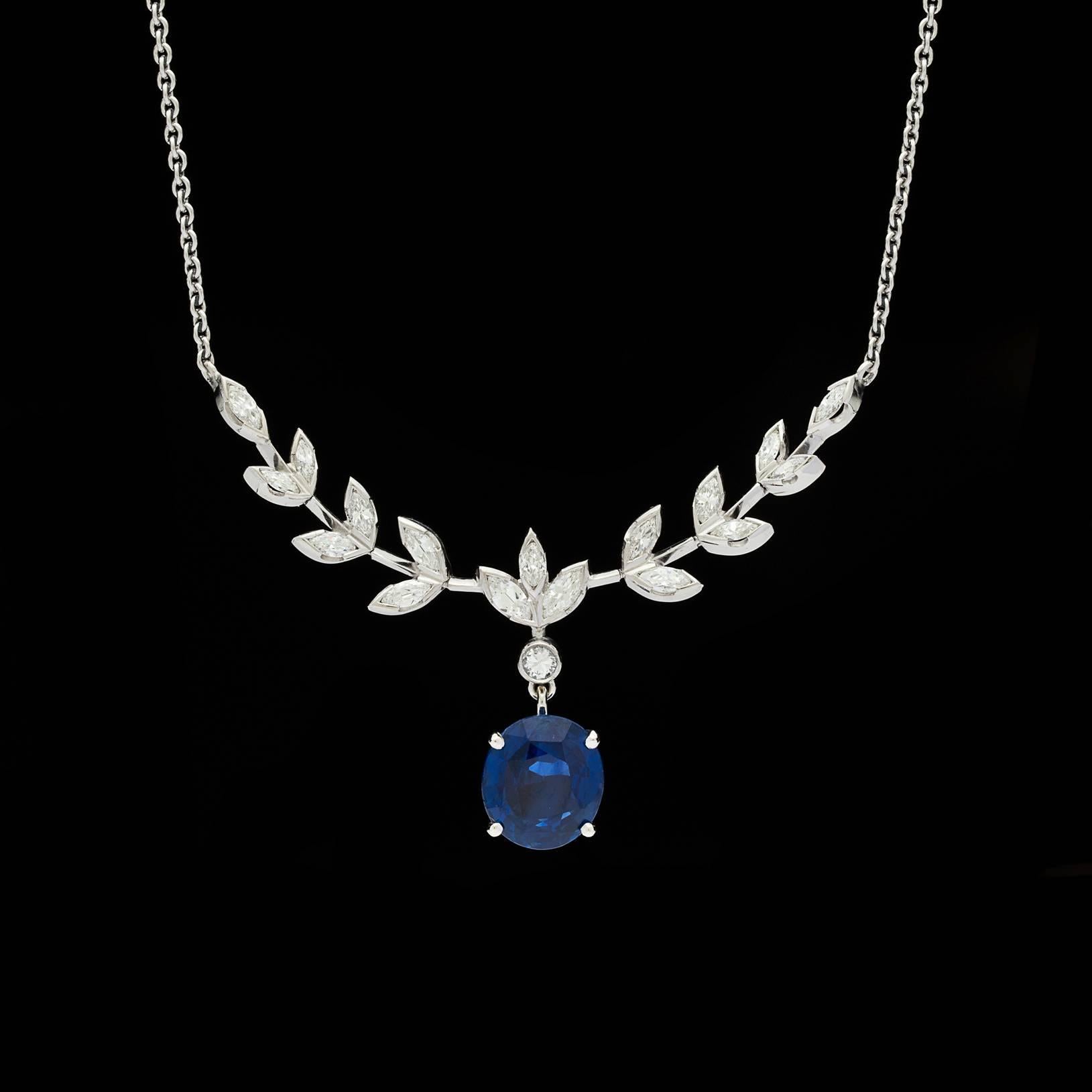 Platinum drop necklace features a GIA 3.79 carat oval cut blue sapphire pendant suspended from a single round brilliant cut diamond.  Seventeen marquise diamonds arranged in a sophisticated leaf motif total approximately 1.00 carat total weight. 