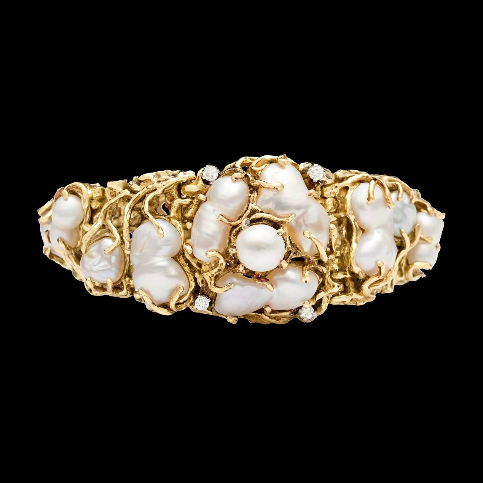 18Kt Yellow Gold bracelet features white Baroque Pearls with rose color overtone & orient, accented with 4 round melee diamonds totaling 0.20 carats.  The bracelet measures 6.5