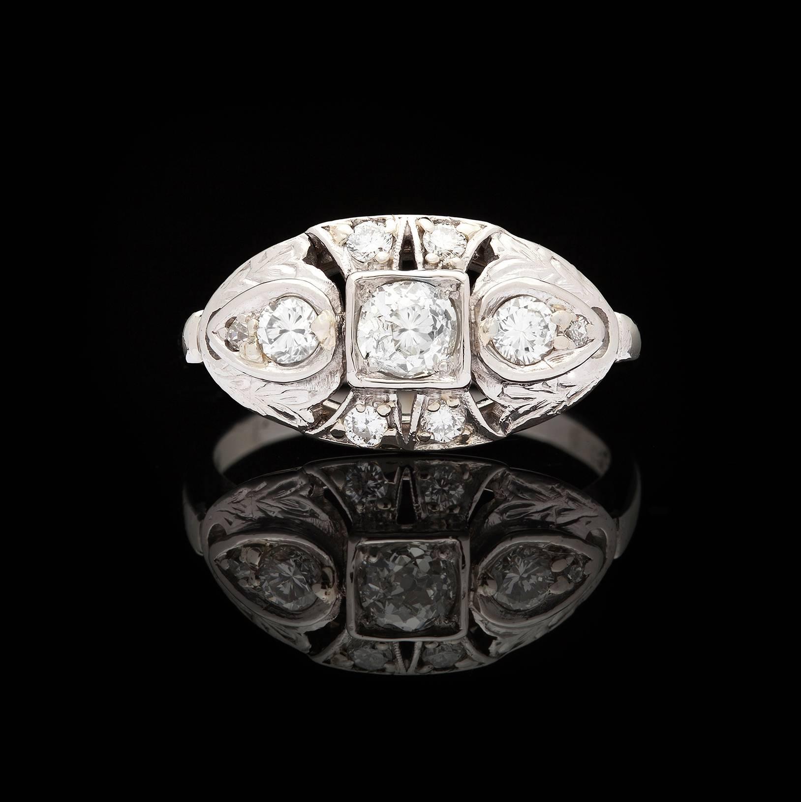 Estate Platinum East West Design Diamond Ring features a 0.45-ct Old European Cut Diamond accented with 6 Round Brilliant & 2 Old European Diamonds totaling 0.30-ctw. Some scroll work & milgrain detail on top of ring. Ring is a size 7.25 and weighs