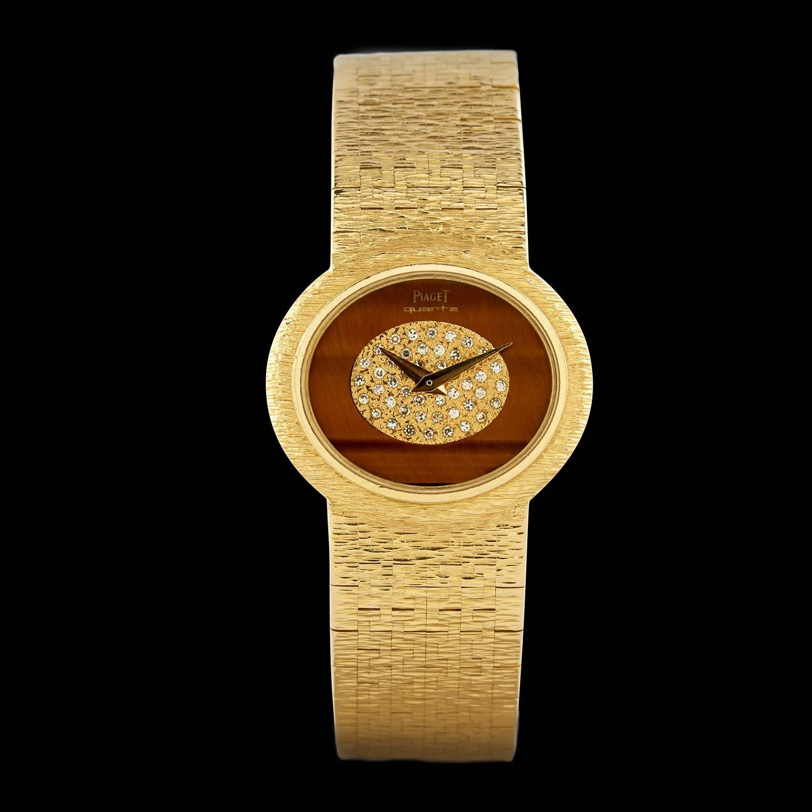 Rare Circa 70s 18K Yellow Gold Piaget Watch with Tigers Eye Quartz Dial & Single Cut Diamonds. The case size of the watch is 27mm on a 0.62″ wide bracelet. There are 24 round single cut diamonds set in the dial of the watch totaling approximately