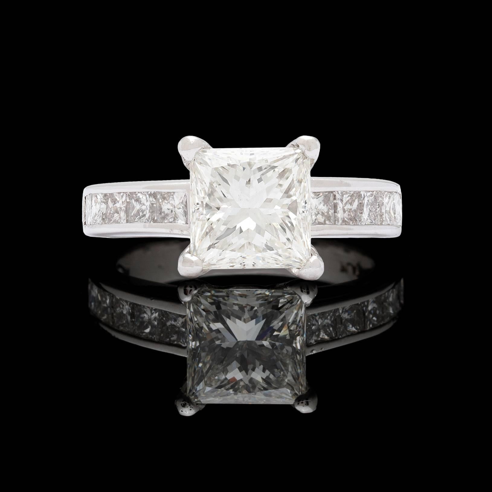 Platinum engagement ring featuring a GIA 2.09 carat modified square brilliant cut diamond accented with 10 princess cut diamonds for a total approximate weight of 1.20 carat. The center stone is H color and SI1 clarity. The ring is currently a size