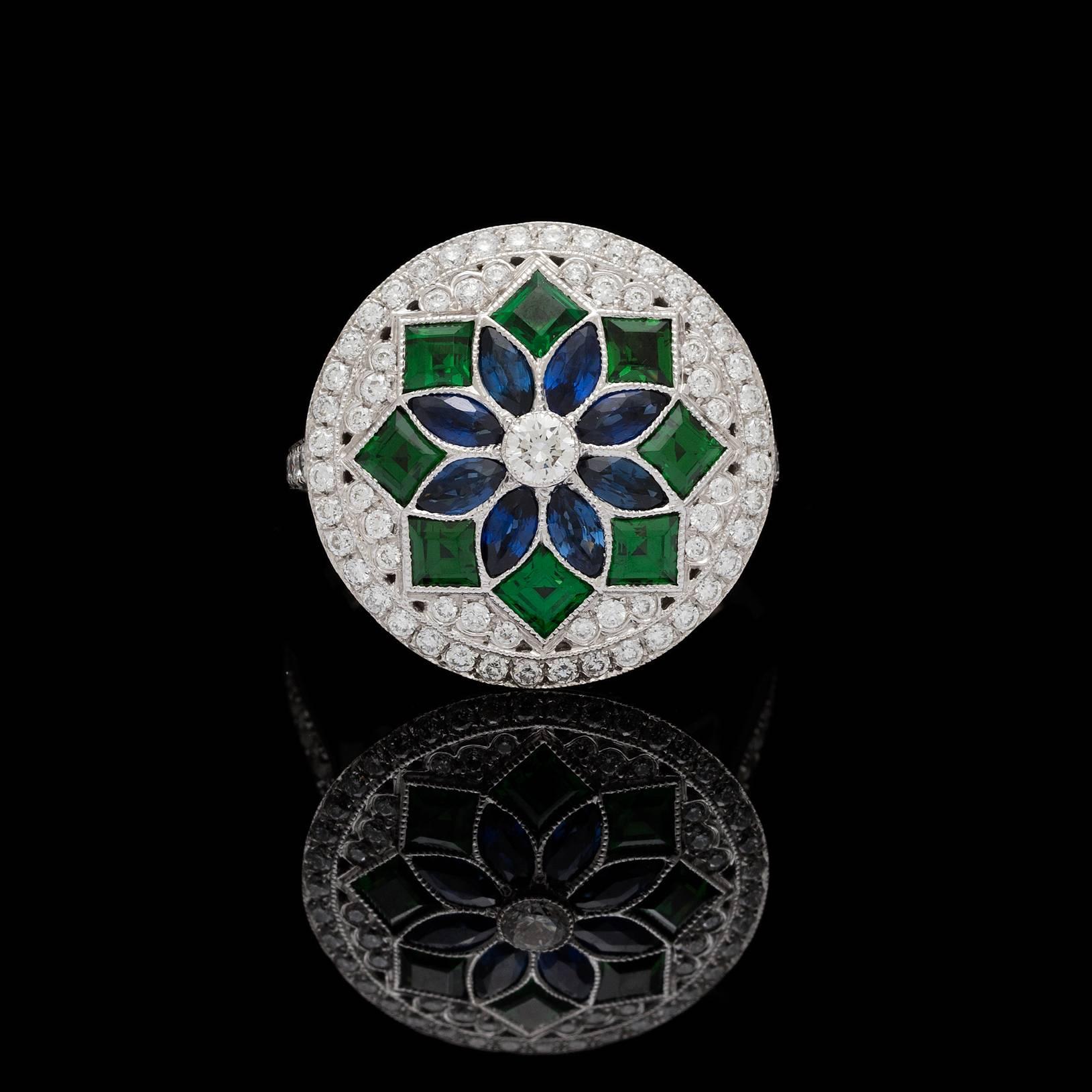 18k white gold Deco style ring features 1.00 carat blue sapphires and 1.20 carat green garnets in a mosaic pattern enhanced with 167 round brilliant cut diamonds weighing 1.73 carat total weight. The ring measures 19.5mm to 1.75mm and is currently a