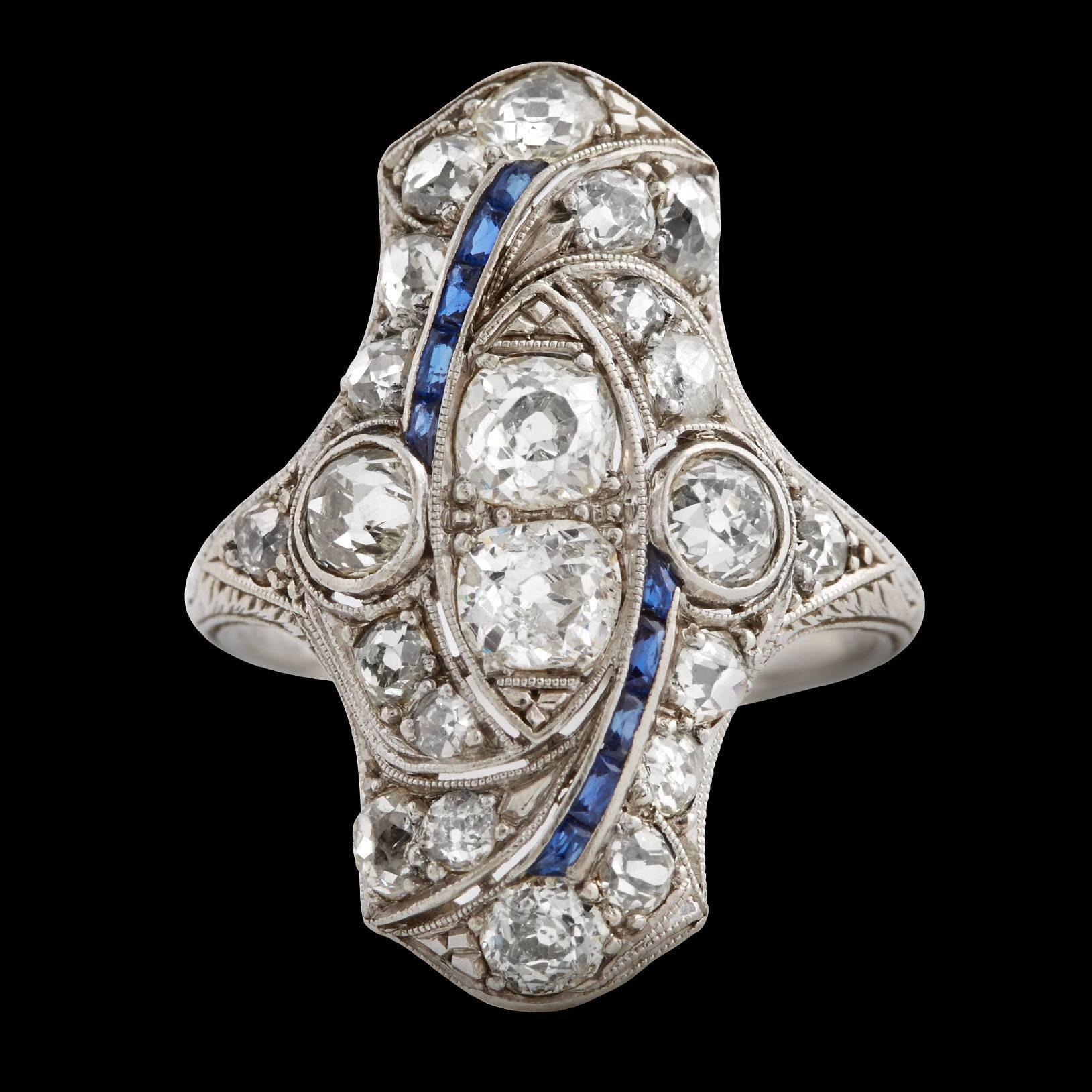 North to South Edwardian Platinum Diamond Ring features 22 Old Mine Cut Diamonds totaling approximately 2.00 carats & detailed with 10 rectangular cut Sapphires totaling approximately 0.50 carats. This Edwardian ring is estimated to be from the
