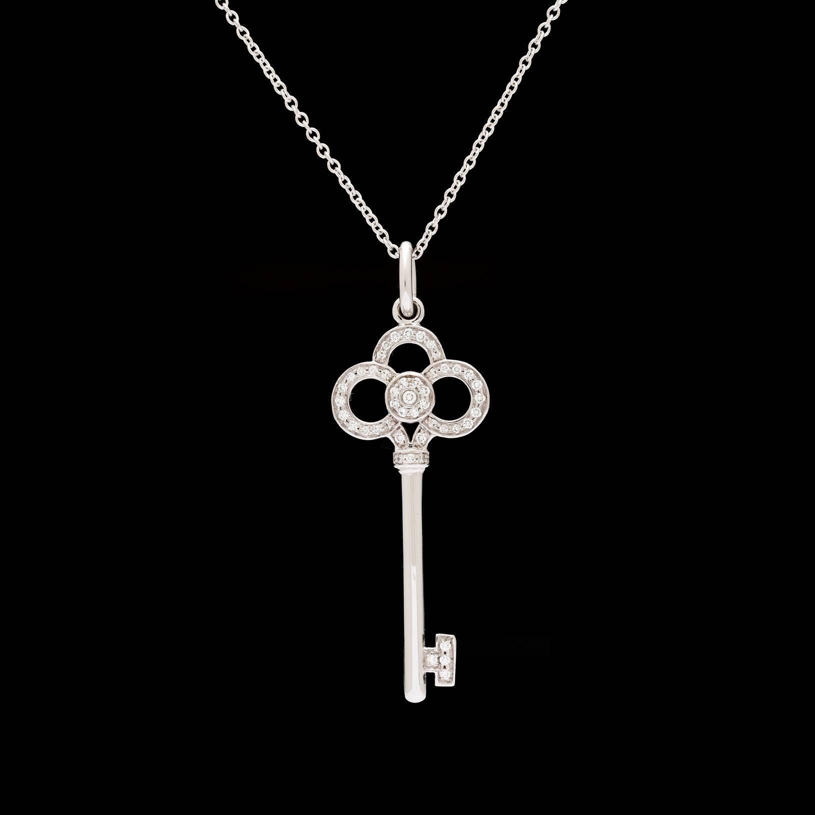 Tiffany & Co. Crown Key collection in 18k white gold and 0.25 carats of round brilliant diamonds. The key pendant measures 1.25″ and chain measures 16″. Total item weight is 4.8 grams. 