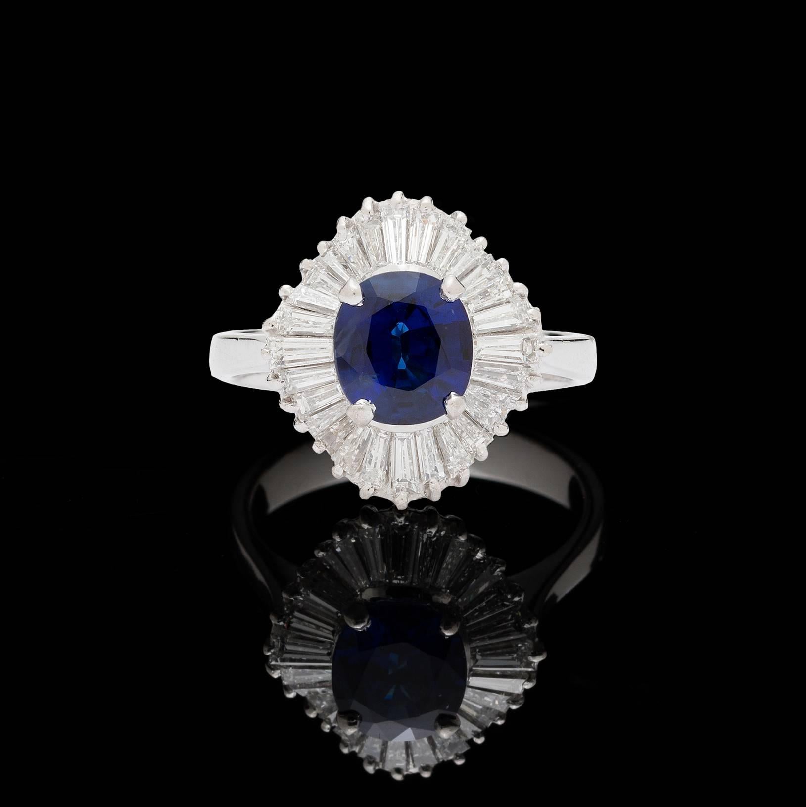 Ballerina 18k white gold ring features a gorgeous blue 2.00 carat cushion cut sapphire surrounded by 28 bright baguette diamonds for a total of 1.75 carats. Ring size is a 6.5 and can be resized. This romantic ballerina ring is a must-have! 