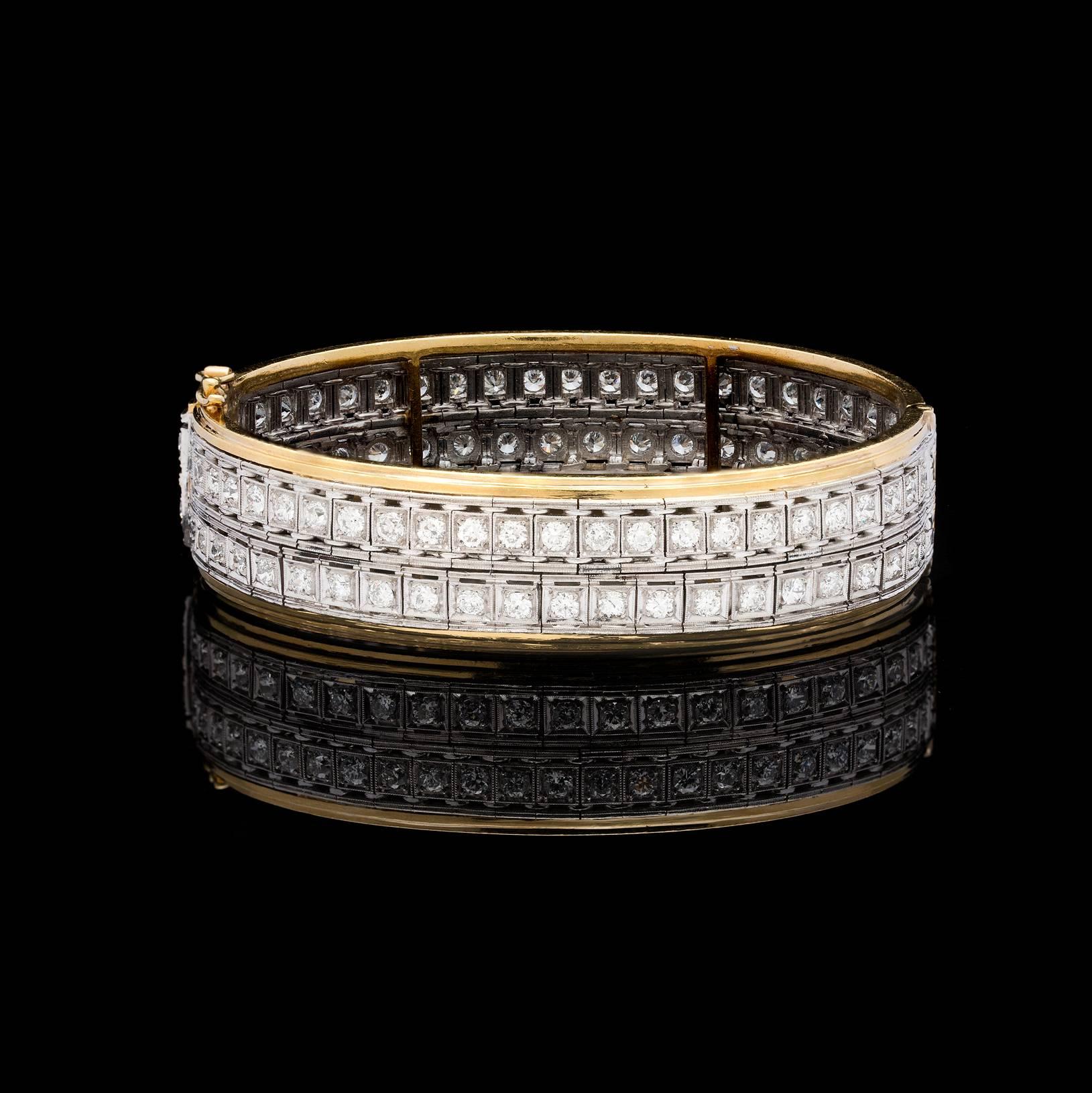 A unique and stunning 1950s piece featuring two re-purposed Art Deco line bracelets converted into a bangle design. This beautifully designed bracelet contains 6.58 carat total weight of old European cut diamonds set in platinum and finished with