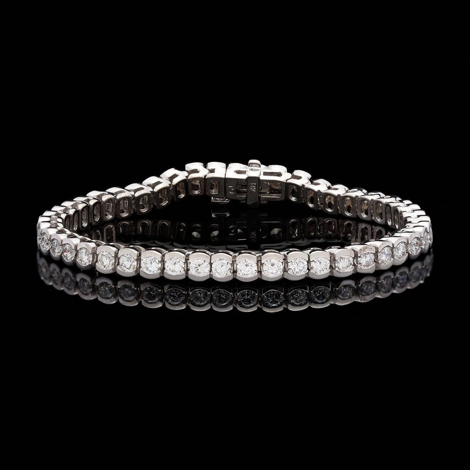 Classic 18k white gold diamond line bracelet featuring 47 round brilliant cut diamonds totaling approximately 5.00 carats set in half bezels. The bracelet is 4.5mm wide and 6 1/2 inches long and weighs 23.1 grams. This staple piece is a beautiful