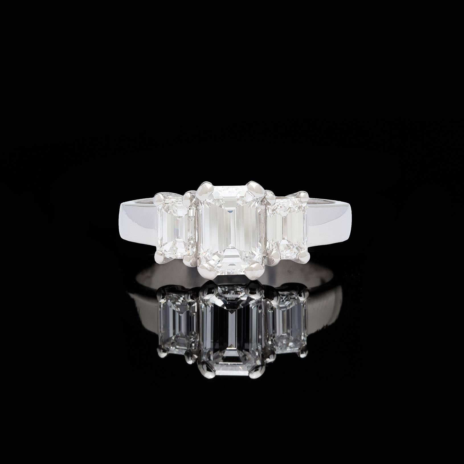 Absolutely beautiful three-stone emerald cut diamond platinum ring featuring a 1.36 carat GIA graded D/VS1 flanked by two fine quality GIA graded emerald cut diamonds. The 0.50 carat side stone has an E/VVS2 grading and the 0.52 carat side stone has