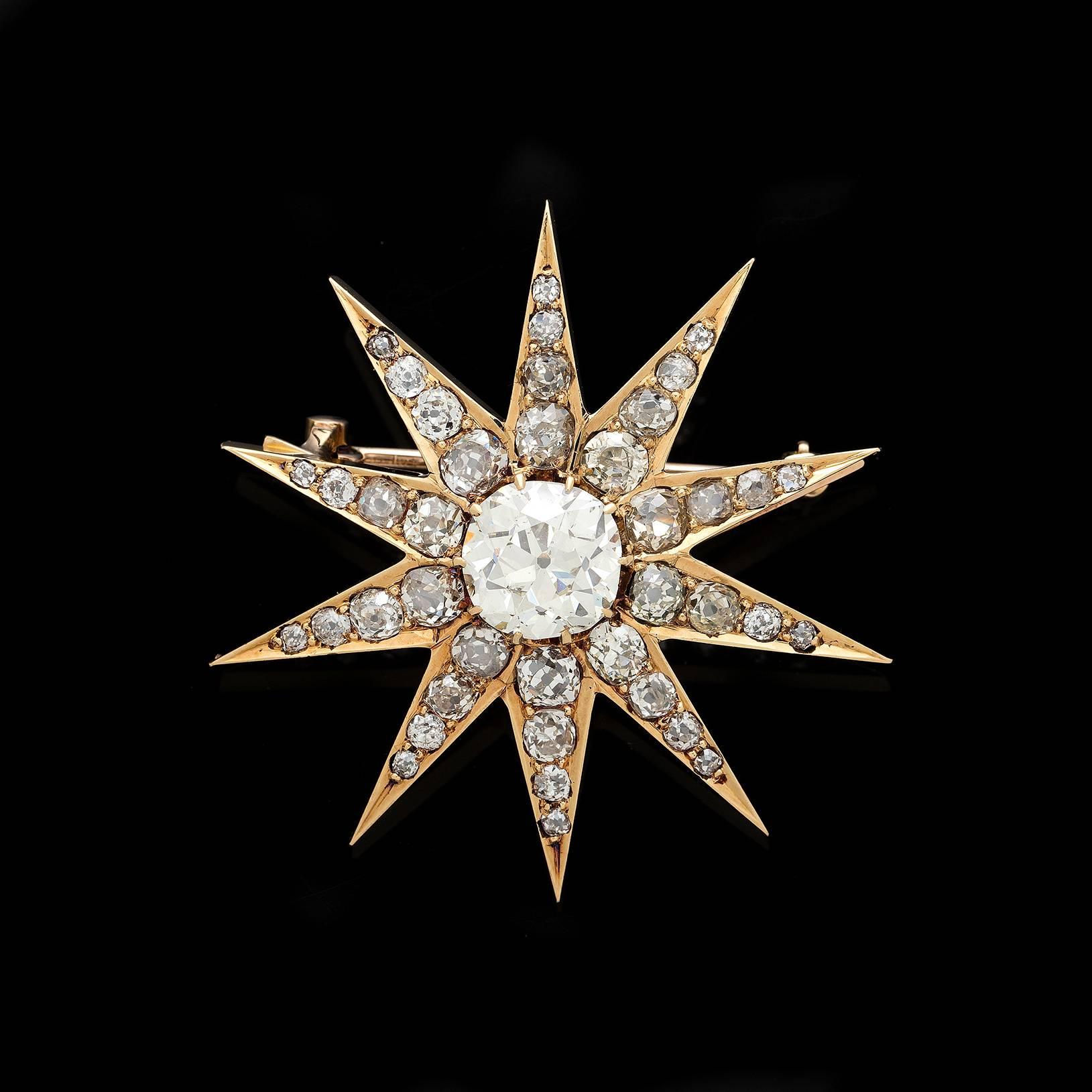 Attention grabbing 14k yellow gold star pin from the Victorian Grand Period circa 1860-1880s. Featured in the center is a 2.25 carat old mine cut diamond surrounded by 40 melee size old mine cut diamonds totaling 2.60 carats. A detail that might be