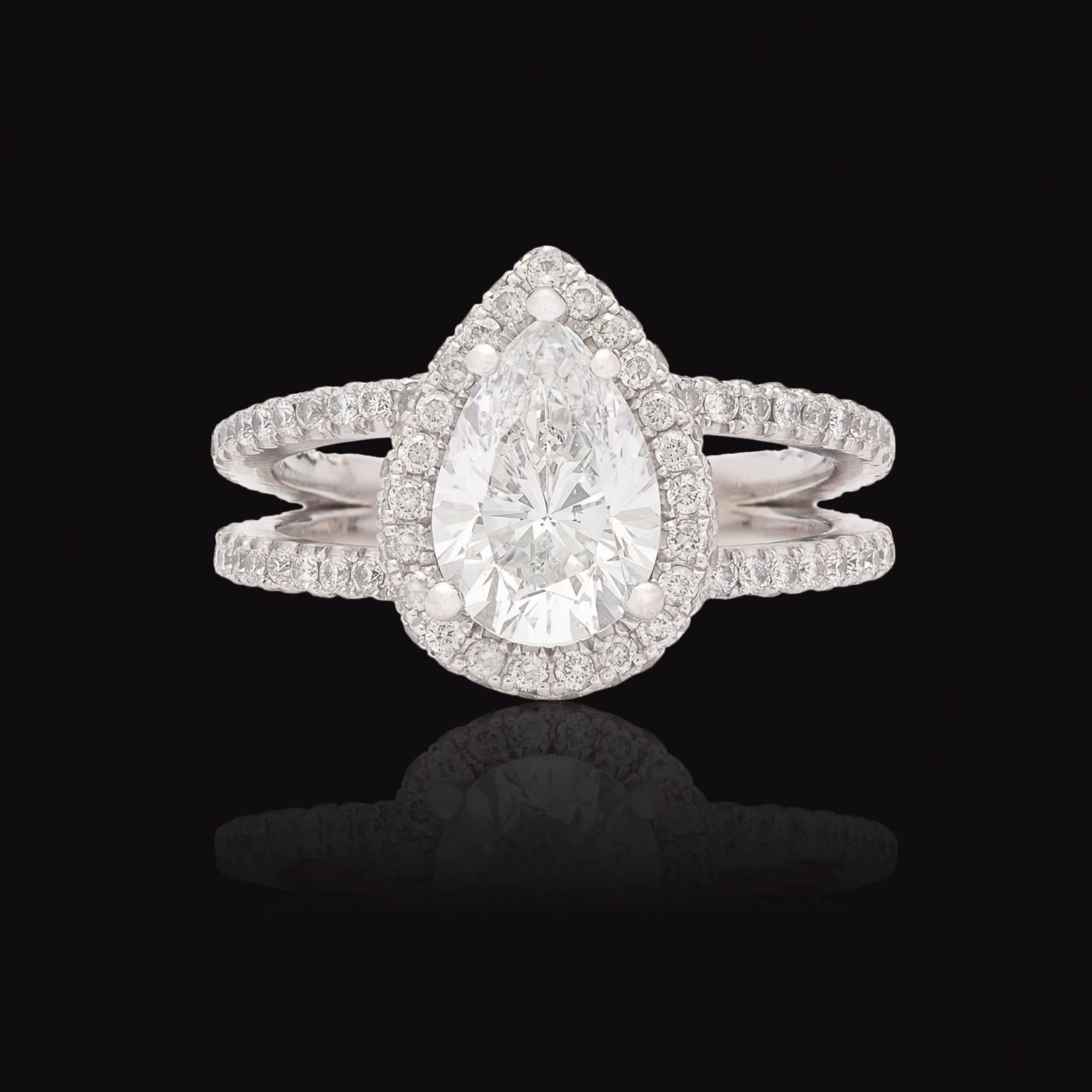 Stunning 14Kt White Gold Halo Design Diamond Ring Set features a GIA D SI1 1.78-ct Pear Brilliant Cut Diamond. There are 121 accent diamonds totaling 1.32 carats. The rings are currently size 5.75 and can be re-sized if needed. The total weight of