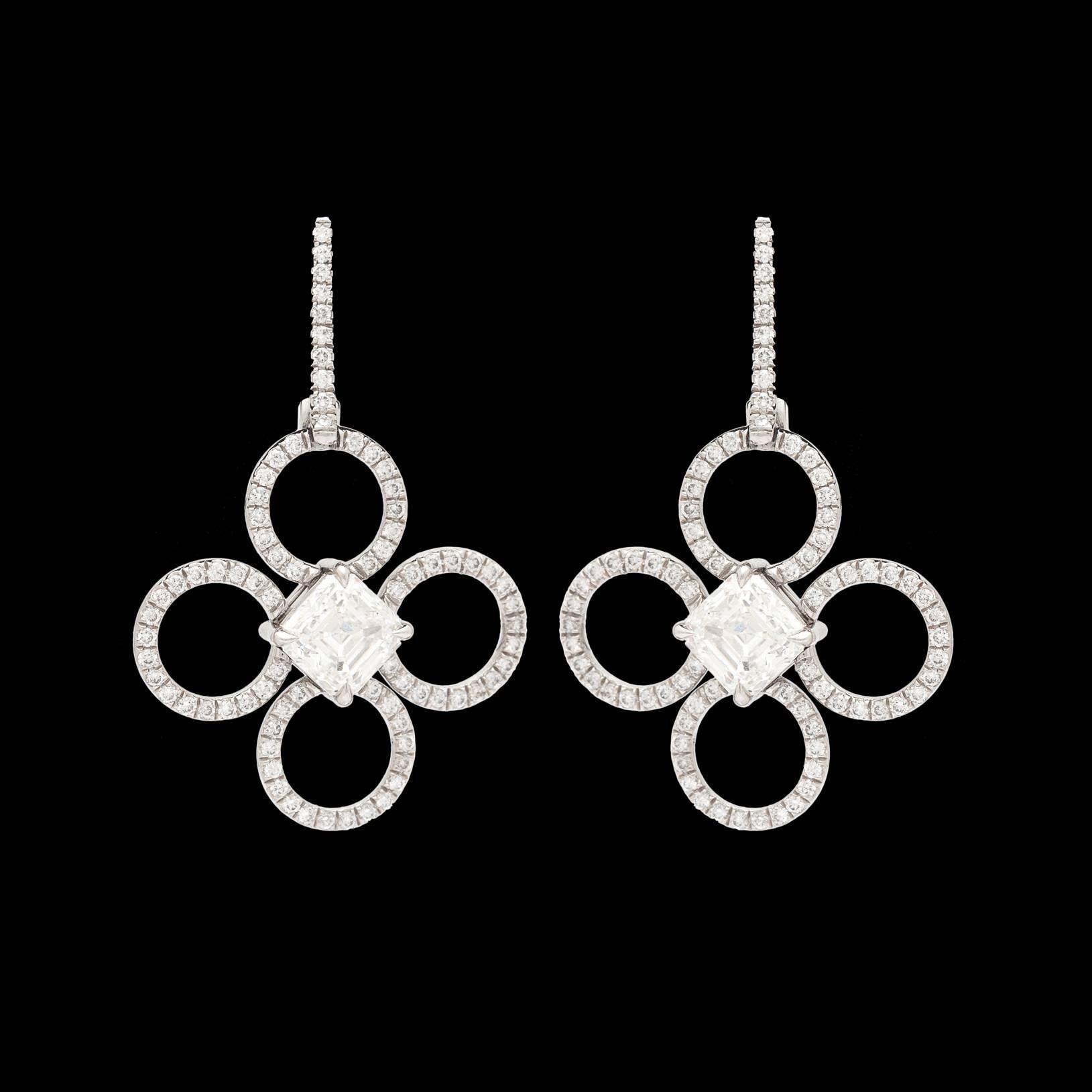 Daniel K. platinum clover earrings features two GIA 0.97-ct H VS1 Asscher Cut Diamonds totaling 1.94-ctw for both. The hand made mountings are enhanced with round brilliant cut diamonds totaling 0.56 carats. Each earring measures 1.25 inches long