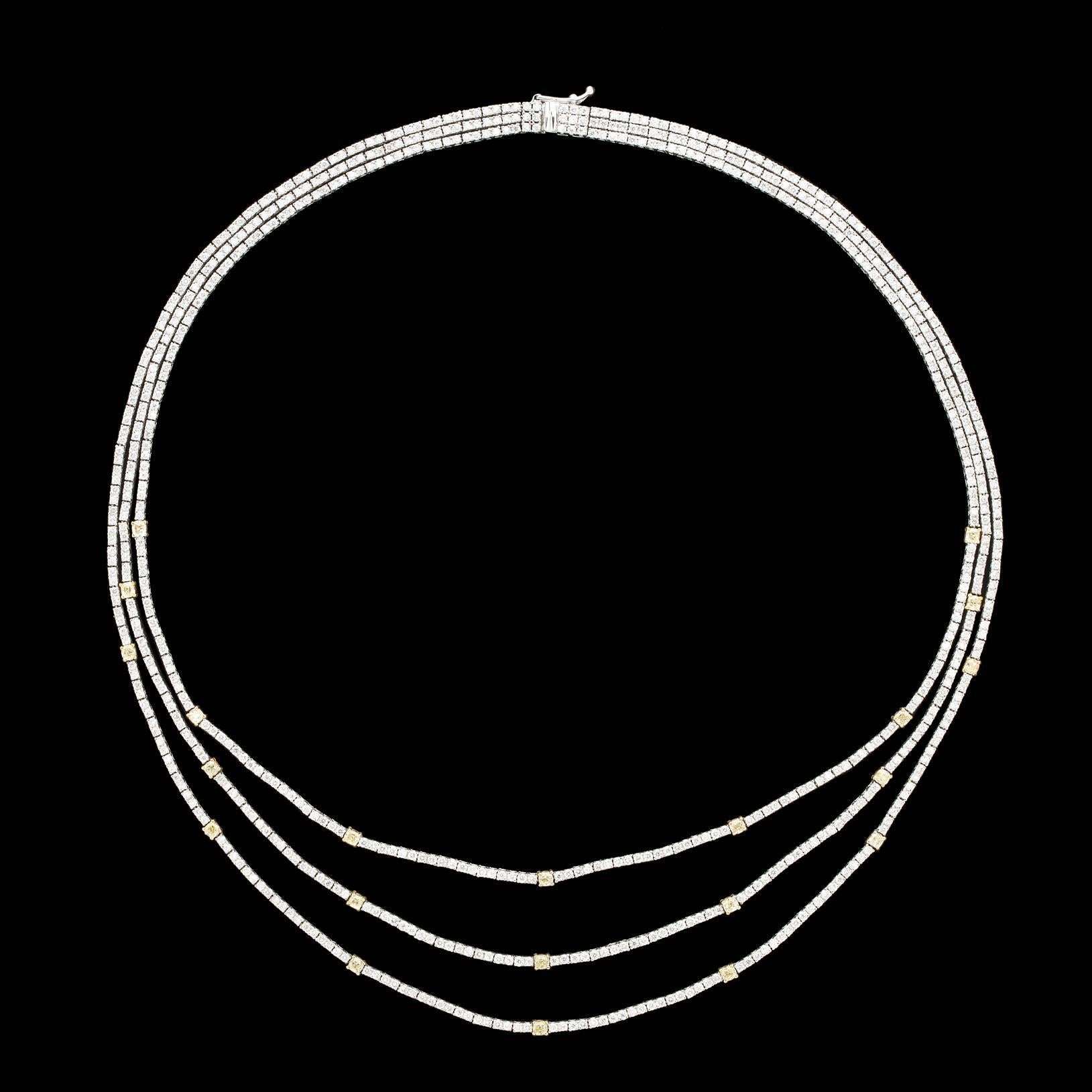 A stunning Salavetti Diamond Necklace Featuring Three 1.5mm to 2.5mm Strands of Round Brilliant Cut Colorless and Fancy Yellow Diamonds Set in 18Kt White and Yellow Gold. The piece is 19 inches long with an approximate total of 10.18 carats of