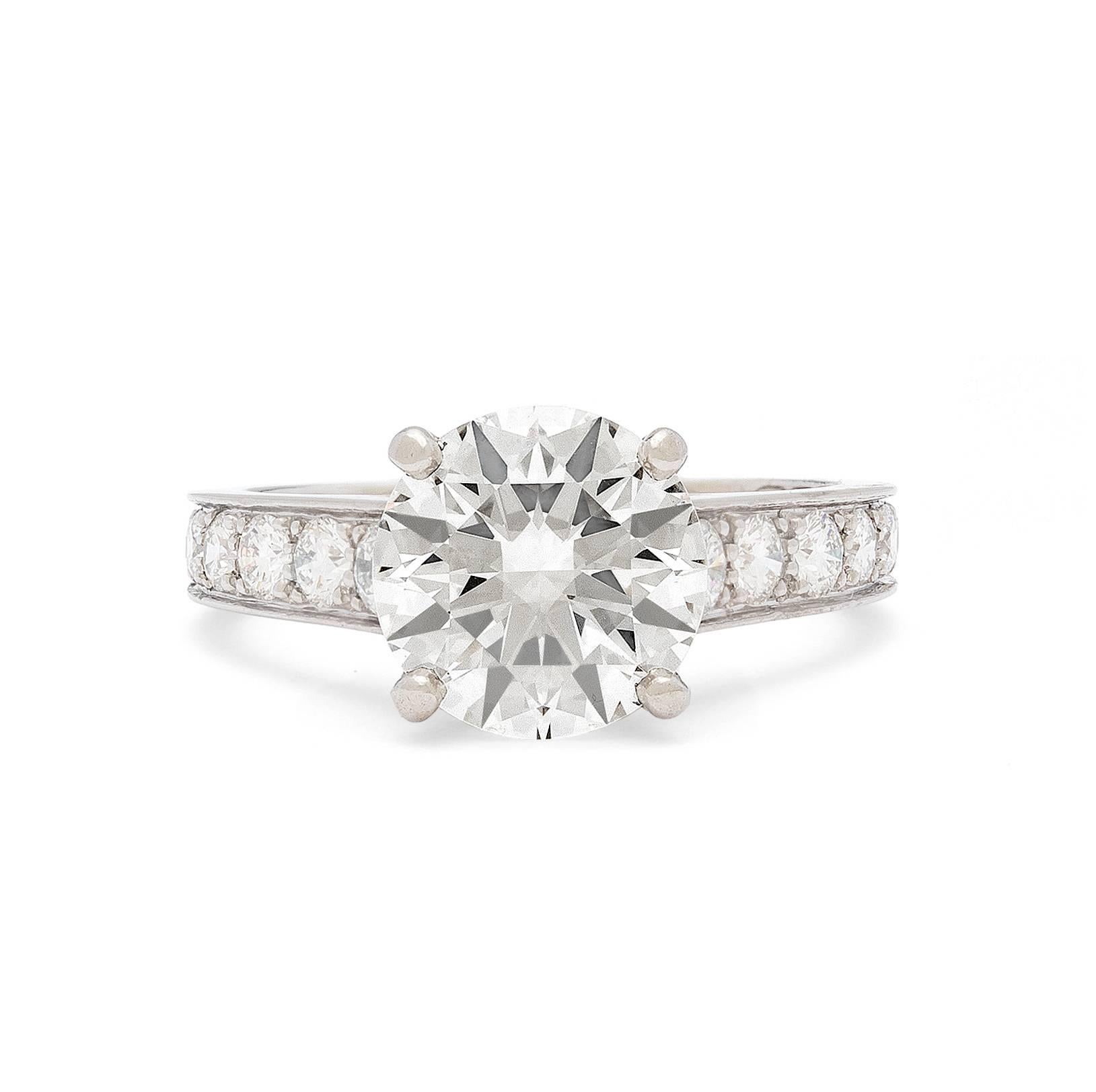 Cartier Solitaire 1895 collection platinum diamond engagement ring features a center 2.41 carat GIA cert round brilliant cut diamond accented with pave diamonds totaling 0.90.  Ring size is a 4.75.  An outstanding Cartier engagement ring.