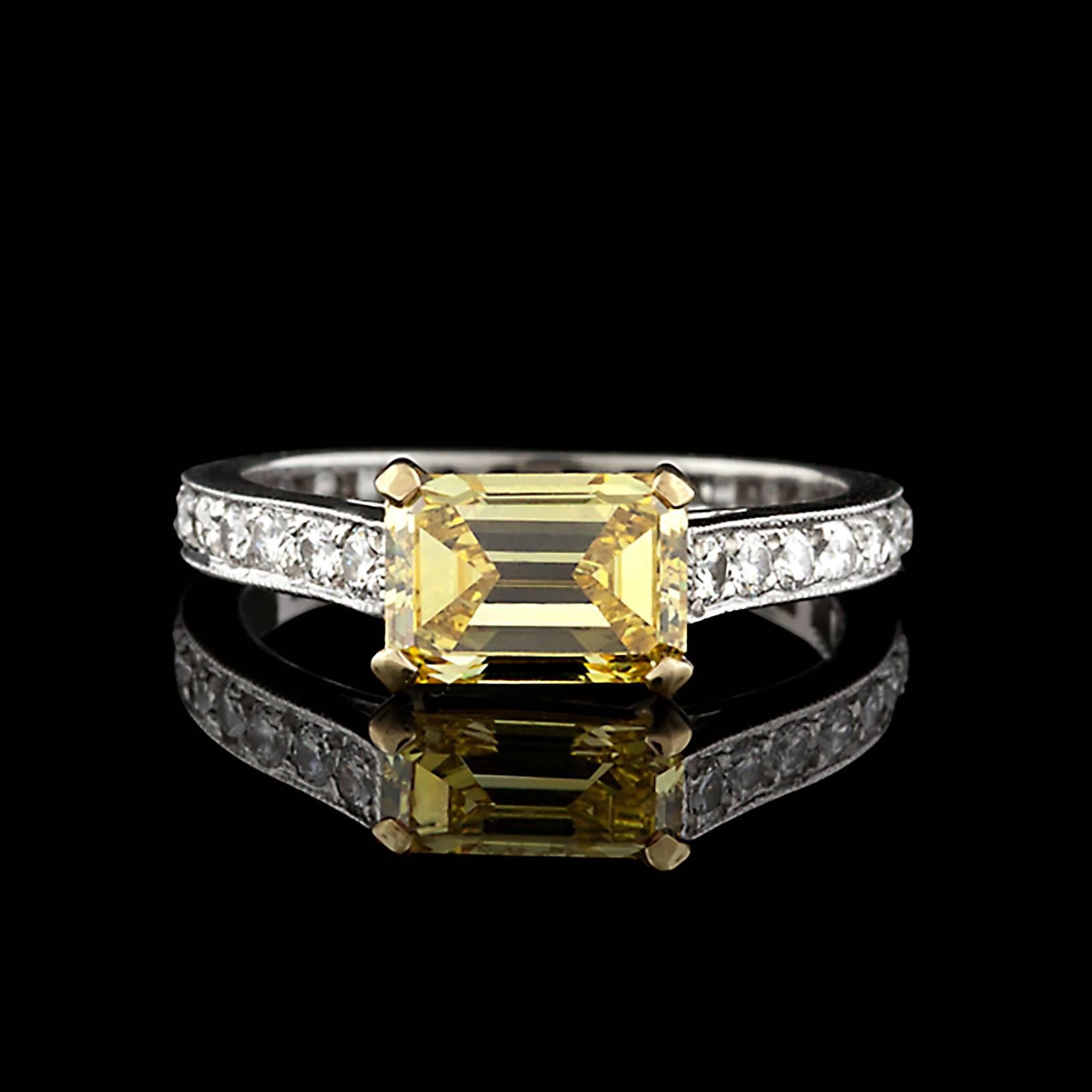 From GRAFF, creators of the "the most fabulous jewels in the world" comes this one of a kind Platinum ring featuring an exquisite 1.34 carat Fancy Vivid Yellow Diamond. This gorgeous deep yellow Emerald Cut stone is set among 28 Round