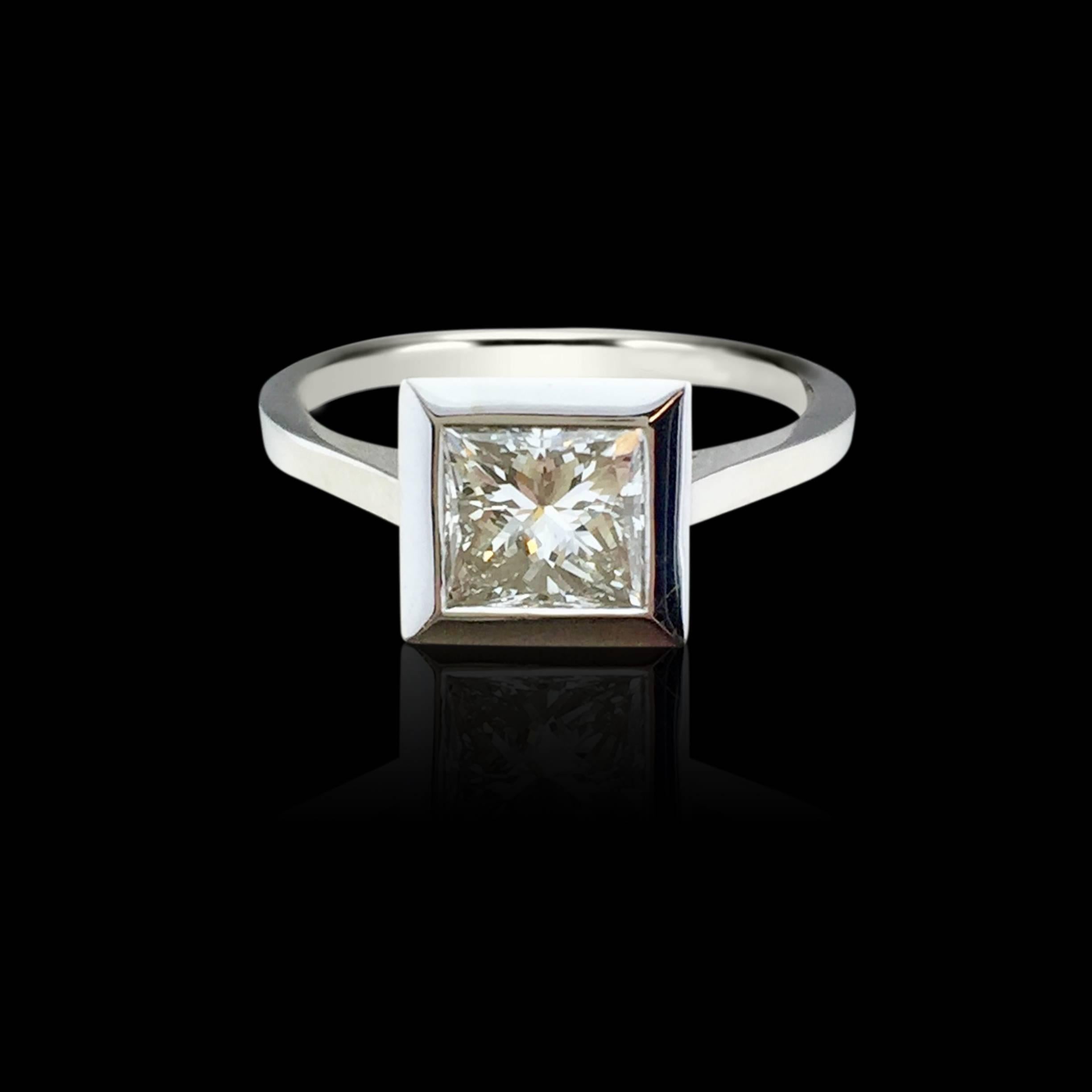 This contemporary low profile ring features a glistening GIA H/VS1 modified rectangular brilliant-cut (princess-cut) diamond weighing 1.06ct, bezel-set in 18k white gold. Currently the ring is a size 5 3/4, and can be adjusted up or down, and weighs