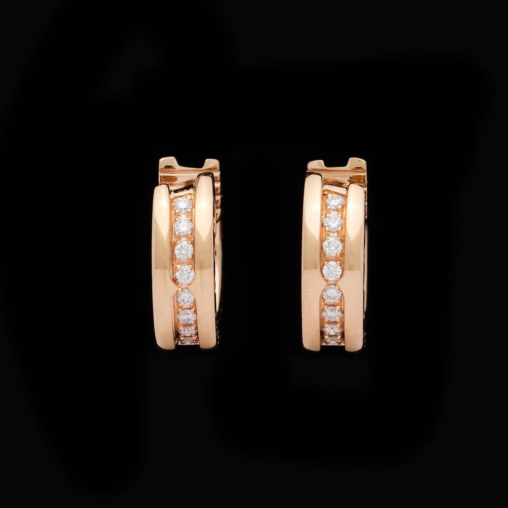 Iconic Bulgari B.Zero1 18Kt Pink Gold Diamond Pave Small Hoop Earrings Featuring 0.16 ctw Round Brilliant Cut Diamonds.  The earrings each have a 1/2 inch diameter and weigh a total of 8.2 grams for the pair.  Original Bulgari packaging is included.