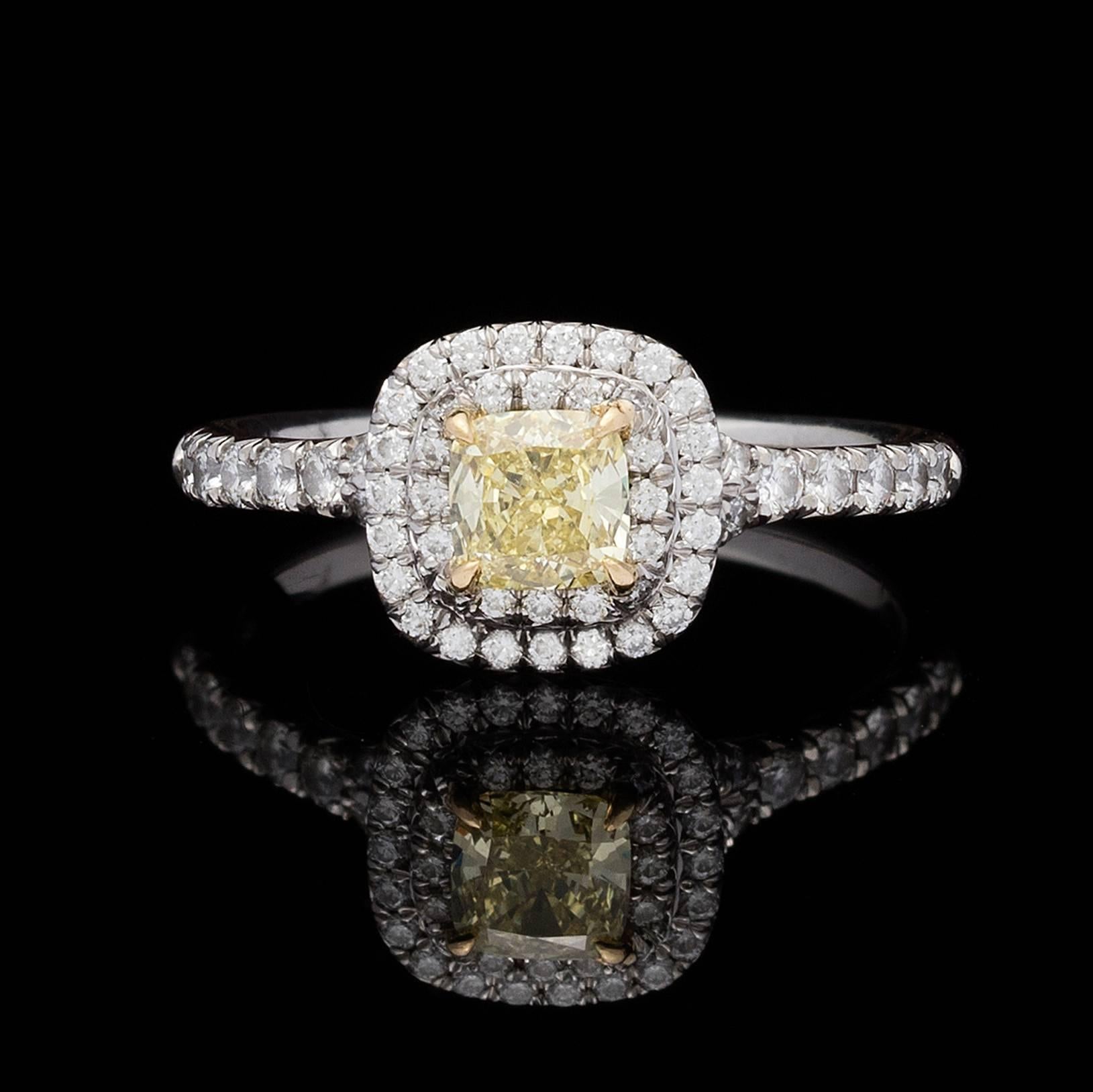 Tiffany & Co Platinum Diamond Ring Features a 0.40 Carat Cushion Cut Fancy Intense Yellow Diamond with a Double Halo of 0.40 ctw. Round Brilliant Cut Diamonds.  The ring is currently a 5.0 and can be sized up or down.  Total weight is 3.6 grams.  A