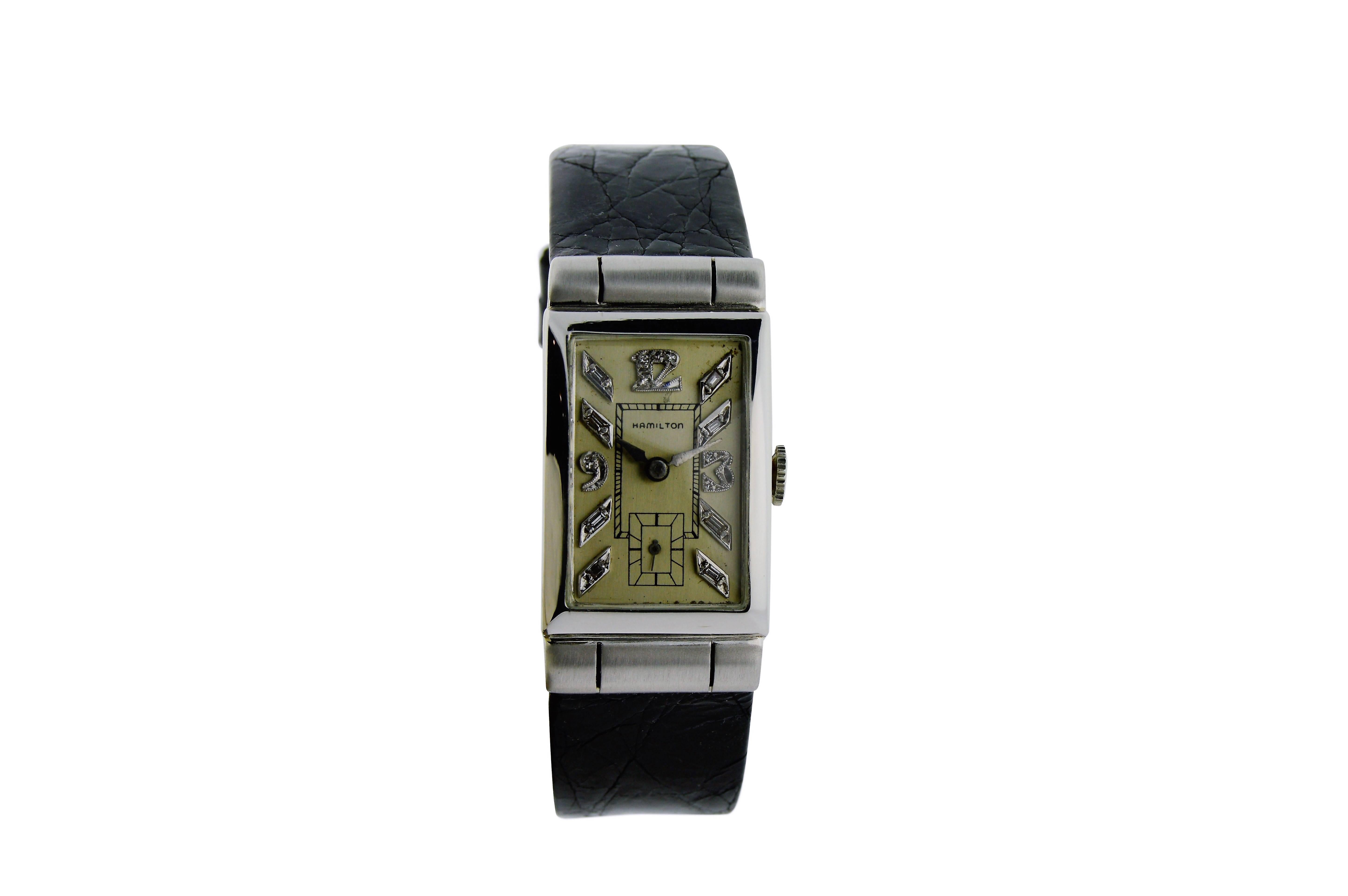 FACTORY / HOUSE: Hamilton Watch Company
STYLE / REFERENCE: Art Deco / Tank Style
METAL / MATERIAL: Platinum
DIMENSIONS: 40mm X 21mm
CIRCA: 1940's
MOVEMENT / CALIBER: Manual Winding / 17 Jewels 
DIAL / HANDS: Original Silvered with Handmade Baguette