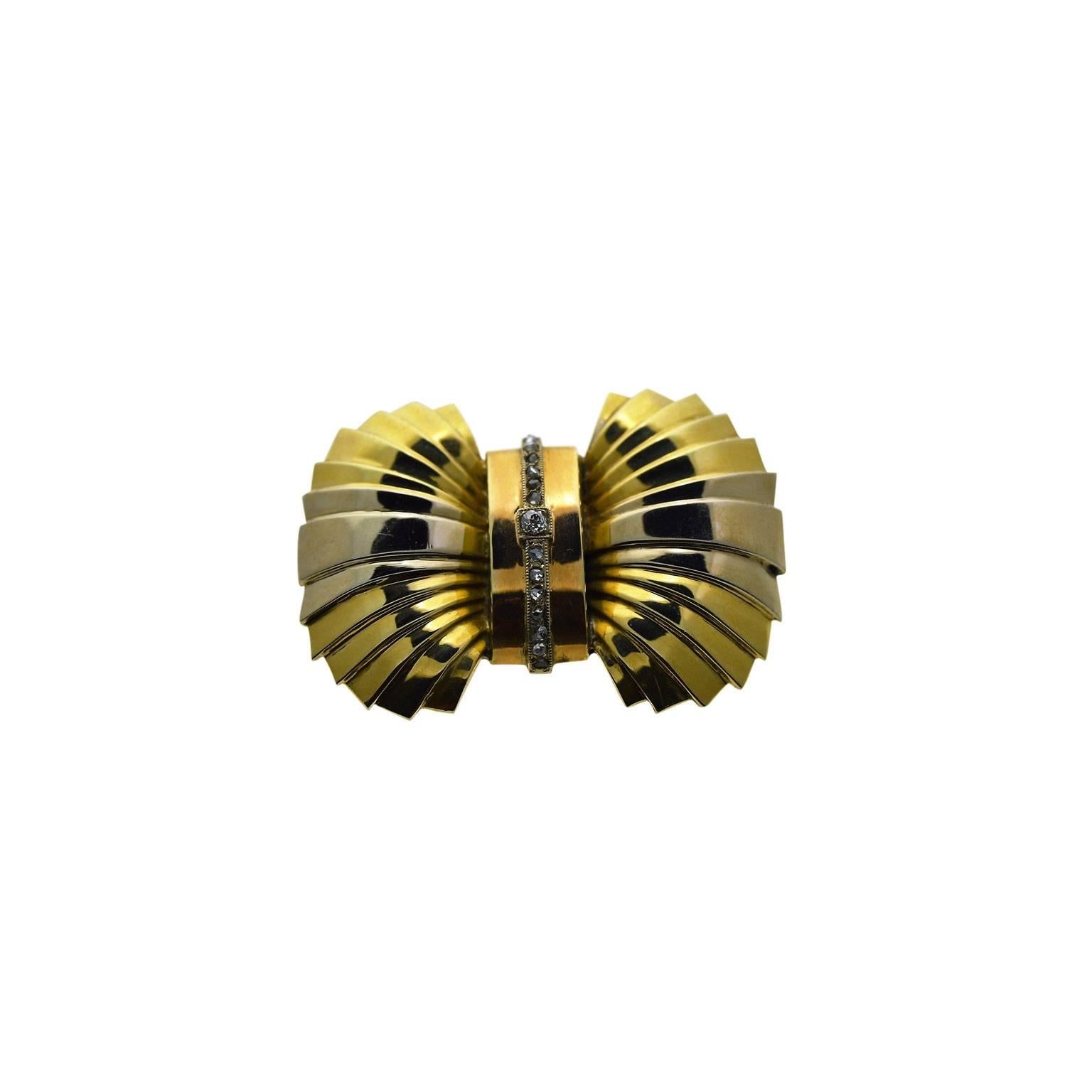 This sophisticated little pin appears to be French by design.
It is done in yellow, rose and white gold and entirely hand constructed.
It is 35mm in length and 26mm in width. 
Uniquely, this pin can be worn by a man as well as a woman as it is