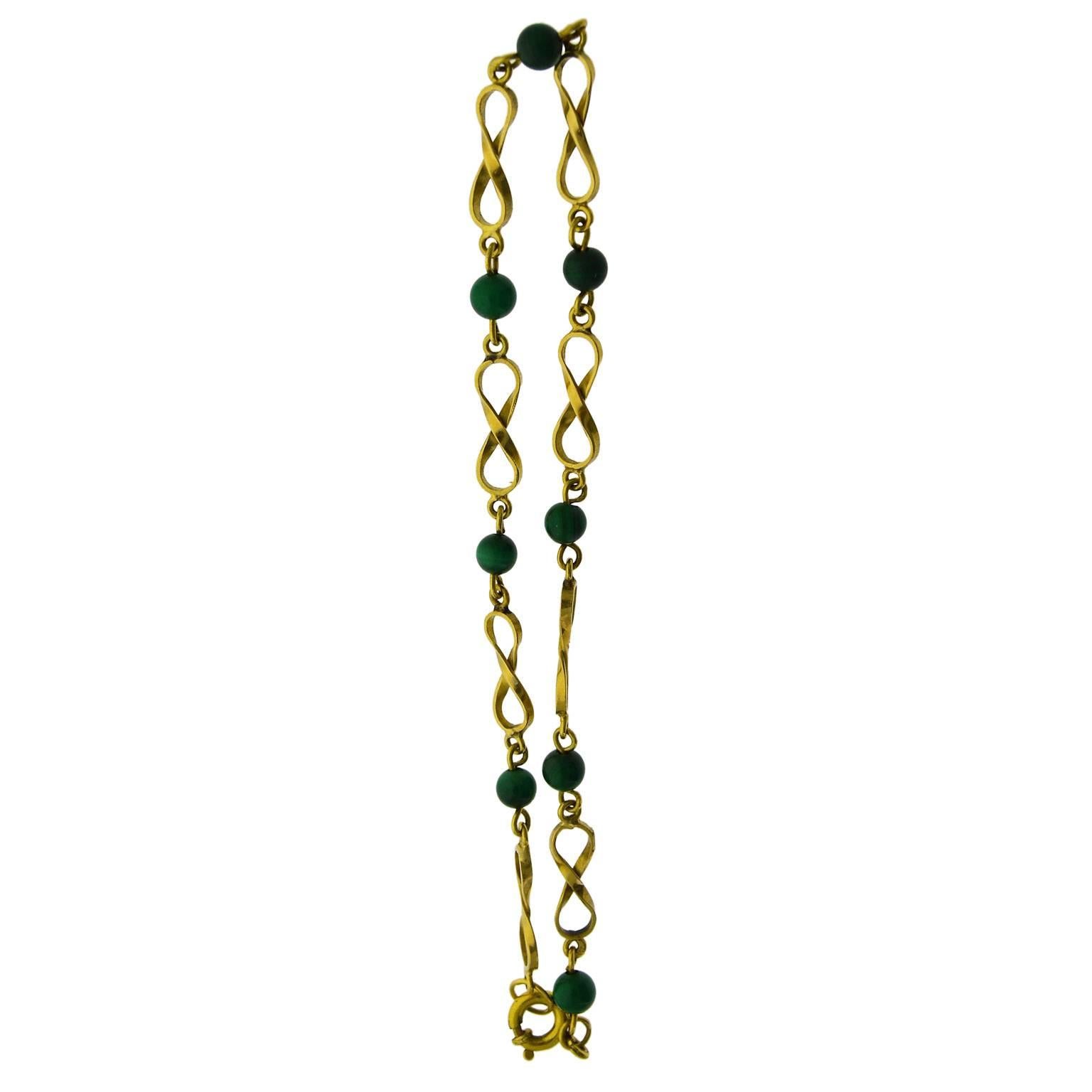 This charming little bracelet is entirely hand constructed. The beads are done in Malachite and the solid 14Kt. gold links are delicately constructed.
The bracelet is 8 inches long, or 20cm. It was likely made in 1930's based on the style and