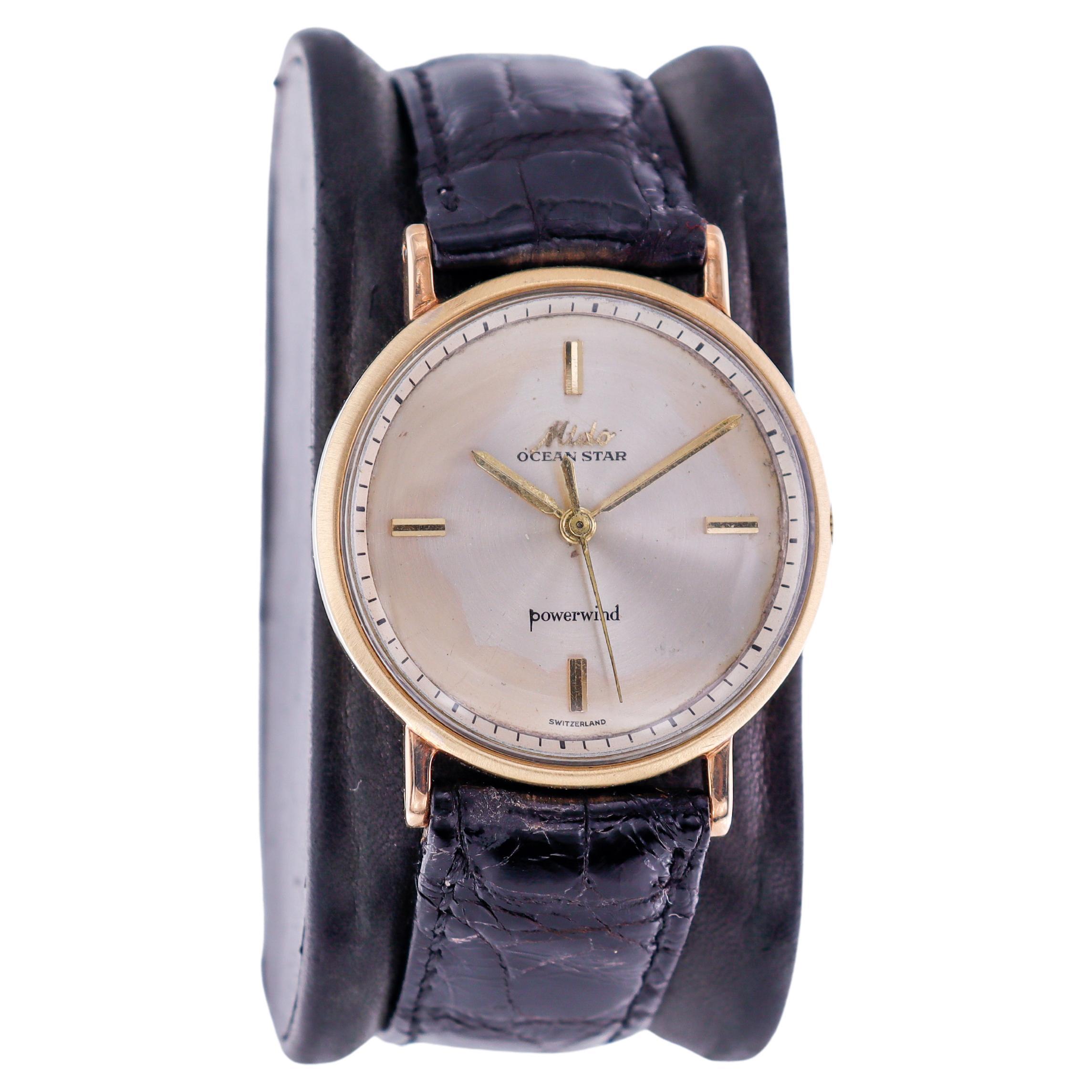 FACTORY / HOUSE: Mido Watch Company
STYLE / REFERENCE: Ocean Star 
METAL / MATERIAL: 14Kt Yellow Gold
DIMENSIONS: Length 39mm X  Diameter 32mm
CIRCA: 1950's
MOVEMENT / CALIBER: Power Winding / 17 Jewels 
DIAL / HANDS: Original Silvered with Baton