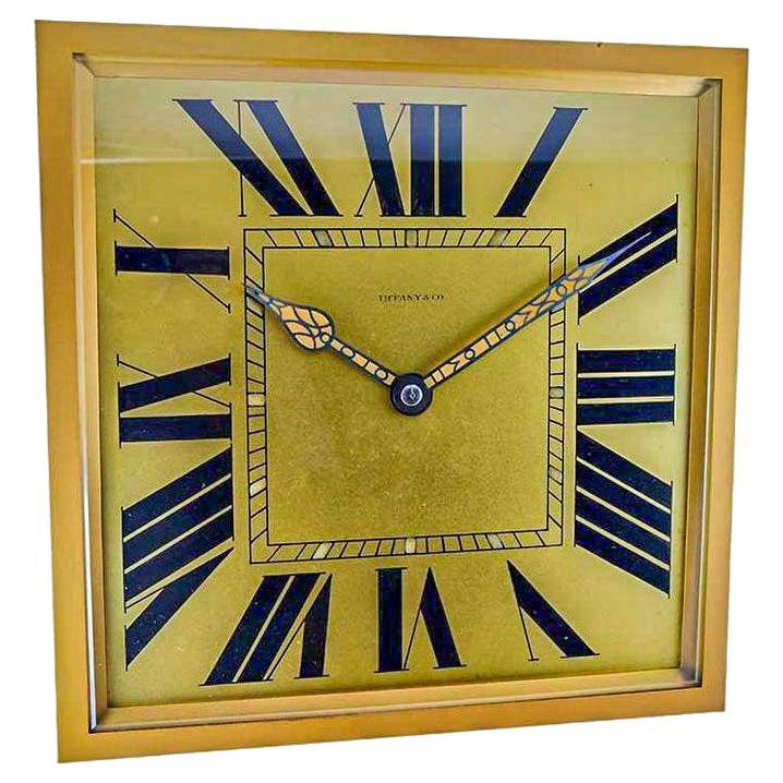 FACTORY / HOUSE: Tiffany & Co. by Charles Hour
STYLE / REFERENCE: Art Deco Desk or Mantle Clock 
METAL / MATERIAL:
CIRCA / YEAR:
DIMENSIONS: Length 10 inch (25cm) X Width 10 inch (25cm) Square
BASE: Original Easel Stand 
MOVEMENT / CALIBER: French,