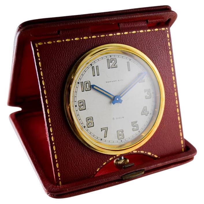 FACTORY / HOUSE: Concord for Tiffany & Co. 
STYLE / REFERENCE: 8 Day Leather Travel Clock
METAL / MATERIAL: Red Leather
CIRCA / YEAR: 1940's
DIMENSIONS / SIZE: 4 Inches Square
MOVEMENT / CALIBER: Manual Winding / 15 Jewels / Concord 8 Days
DIAL /