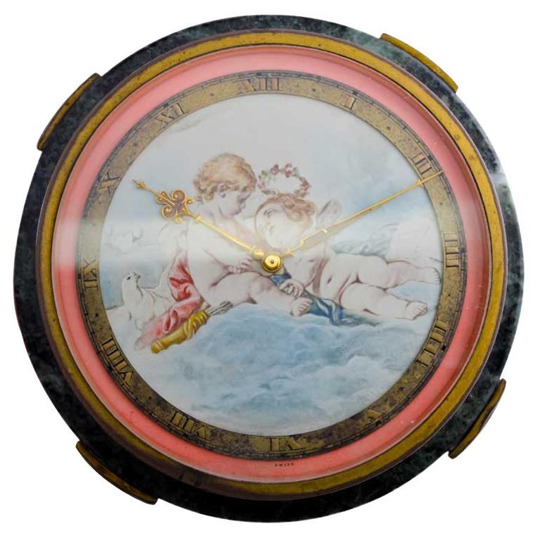 FACTORY / HOUSE: E. Gubelin Lucerne
STYLE / REFERENCE: Art Deco / Round Table Clock
METAL / MATERIAL: Stone & Metal
CIRCA / YEAR: 1930's
DIMENSIONS / SIZE: 5 Inches X 5 Inches 2 Inches Tall
MOVEMENT / CALIBER: Manual Winding / 15 Jewels / 8