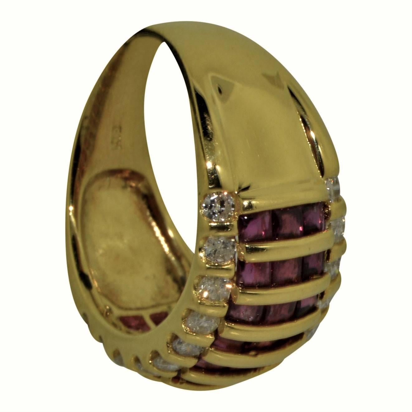 This striking band is crafted in 18K yellow gold and features vertically set rows of channel set, buff cut, natural rubies weighing approx 1.00cts, flanked on each side with sparkling white round diamonds, all VS/SI1 clarity and G/H color. Slightly