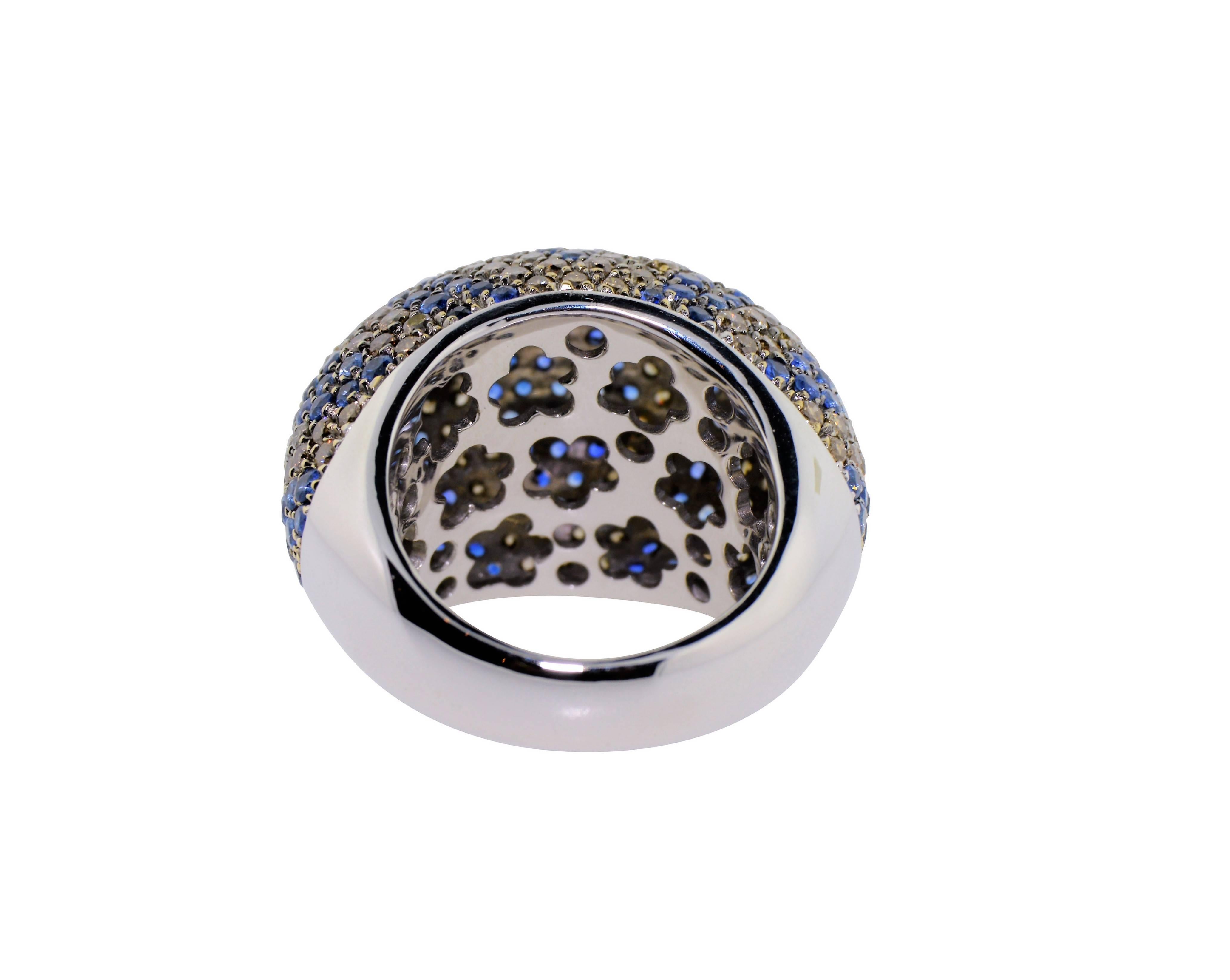 This big, bold, sparkling dome ring is a real show stopper! Expertly crafted in 18K White Gold, the entire top and side surfaces are covered with bright, fine color, natural blue sapphires and natural cognac color diamonds in a fun, unusual pattern.