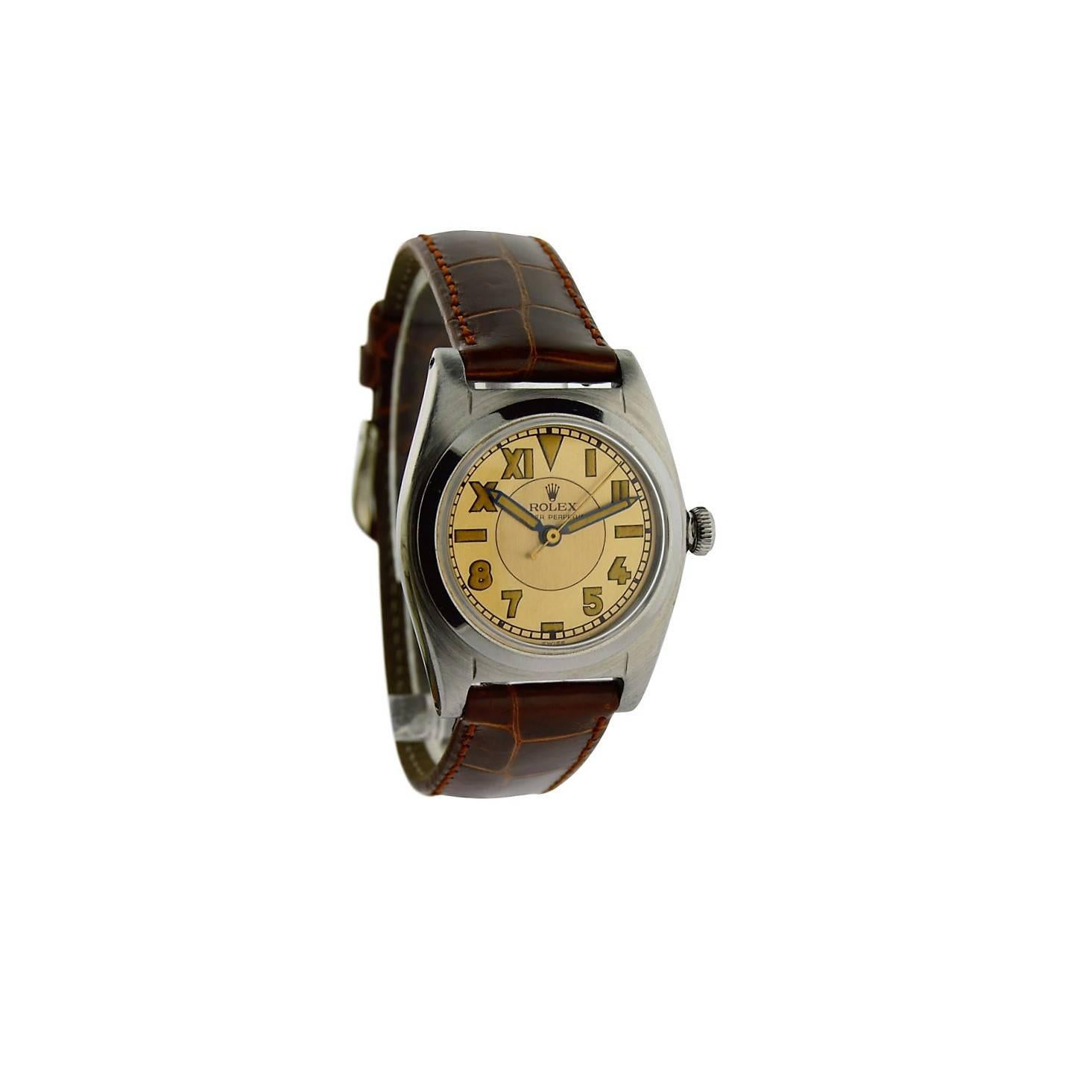 FACTORY / HOUSE: Rolex Watch Company
STYLE / REFERENCE: Bubble Back / Romabic
METAL / MATERIAL: Stainless Steel 
DIMENSIONS:  39mm  X  32mm
CIRCA: 1943-45
MOVEMENT / CALIBER: Perpetual Winding / 17 Jewels / Cal. N.A.
DIAL / HANDS: Romabic Two Tone