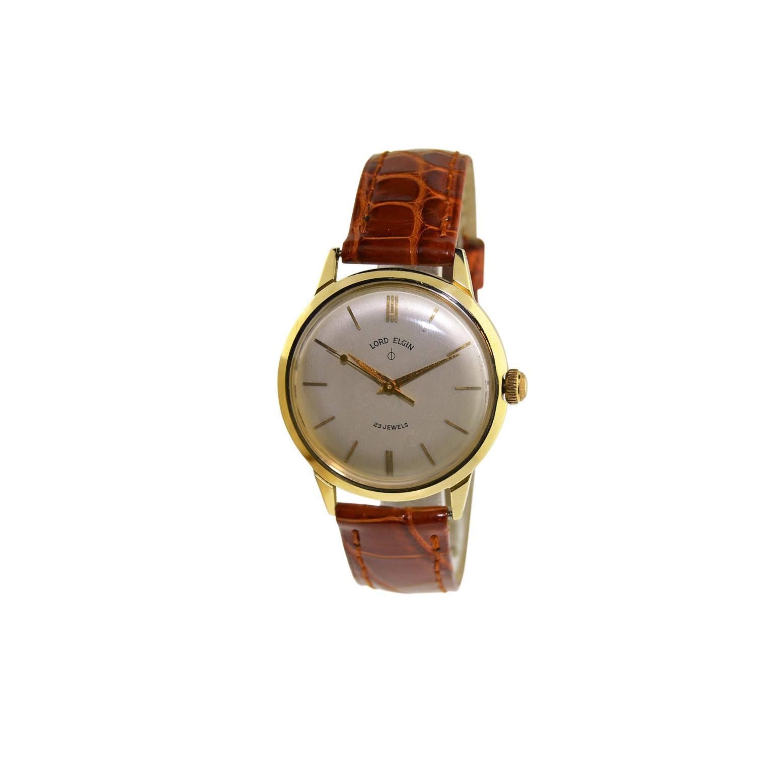 FACTORY / HOUSE:  Elgin Watch Company
STYLE / REFERENCE: Moderne / Dress Style
METAL / MATERIAL:  14 Kt Yellow Gold 
DIMENSIONS: 41 mm  X 35  mm
CIRCA: 1950's 
MOVEMENT / CALIBER:  Manual Winding /  23 Jewels 
DIAL / HANDS:  Original Silvered Satin