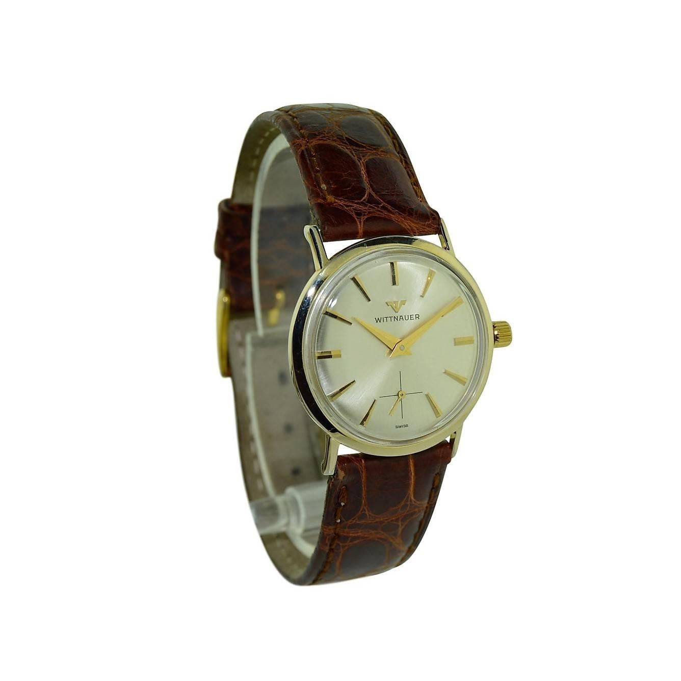 FACTORY / HOUSE: Wittnauer Watch Company
STYLE / REFERENCE: Round / Dress Model
METAL / MATERIAL: 14 Kt Solid Gold
DIMENSIONS: 34 mm X 30 mm
CIRCA:  1960's
MOVEMENT / CALIBER: Manual Winding / 17 Jewels
DIAL / HANDS: Silvered with Baton Markers /