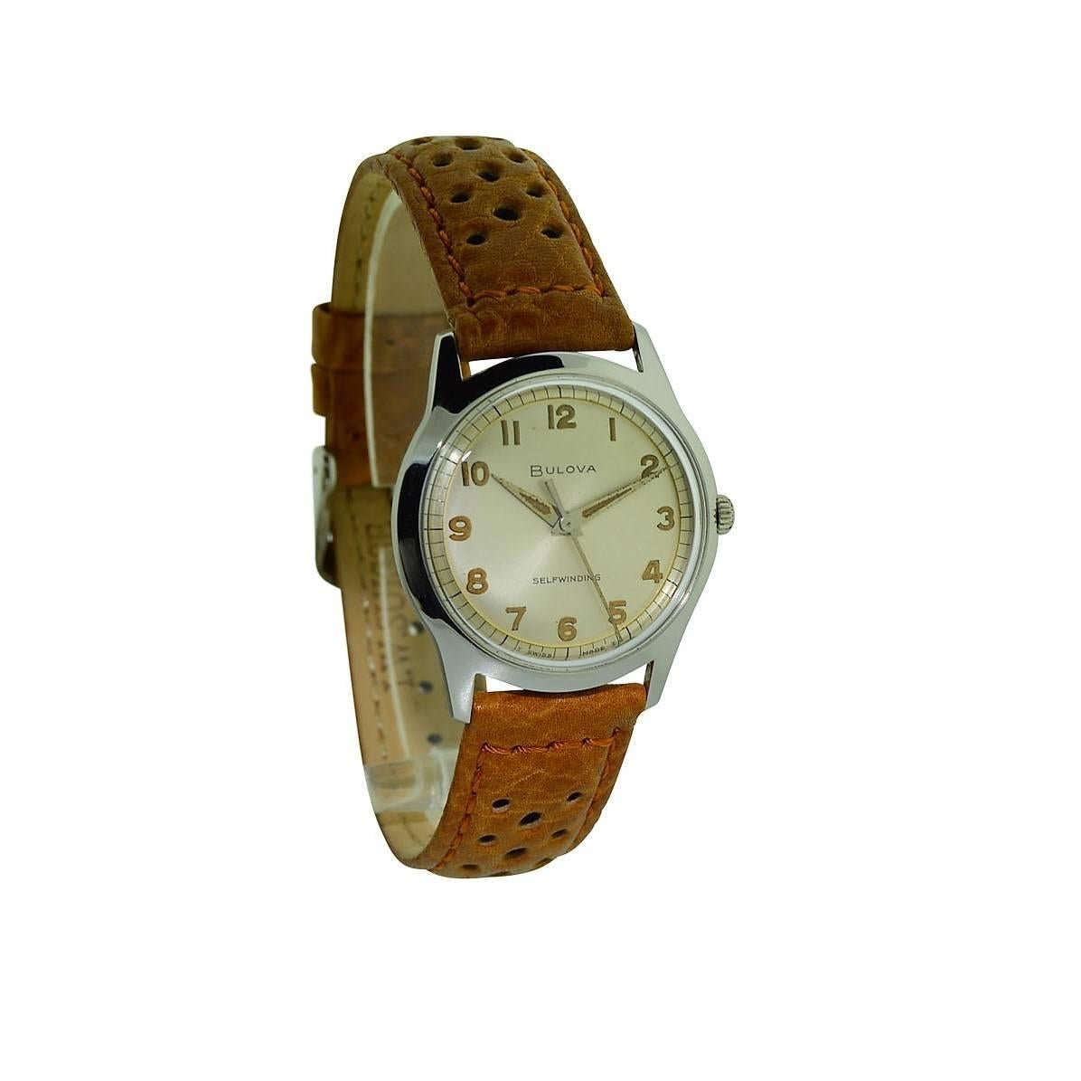 FACTORY / HOUSE:  Bulova Watch Company
STYLE / REFERENCE: Round 
METAL / MATERIAL: Stainless Steel 
DIMENSIONS:  38 mm  X 32 mm
CIRCA:  1950's
MOVEMENT / CALIBER:  Automatic Winding / 23 Jewels 
DIAL / HANDS: Original Silvered with Luminous Arabic