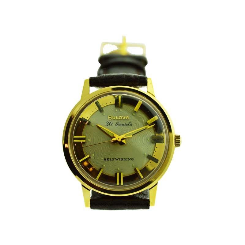 FACTORY / HOUSE: Bulova Watch Company
STYLE / REFERENCE: Round Automatic
METAL / MATERIAL: Yellow Gold Filled
DIMENSIONS:  39mm X 33mm
CIRCA: 1960's
MOVEMENT / CALIBER: Self Winding / 30 Jewels / Cal.
DIAL / HANDS: Original Gilt with Baton Markers /