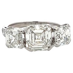 Vintage White Platinum Three-Stone Ring with 3.92 Carat Asscher Cut Diamonds GIA