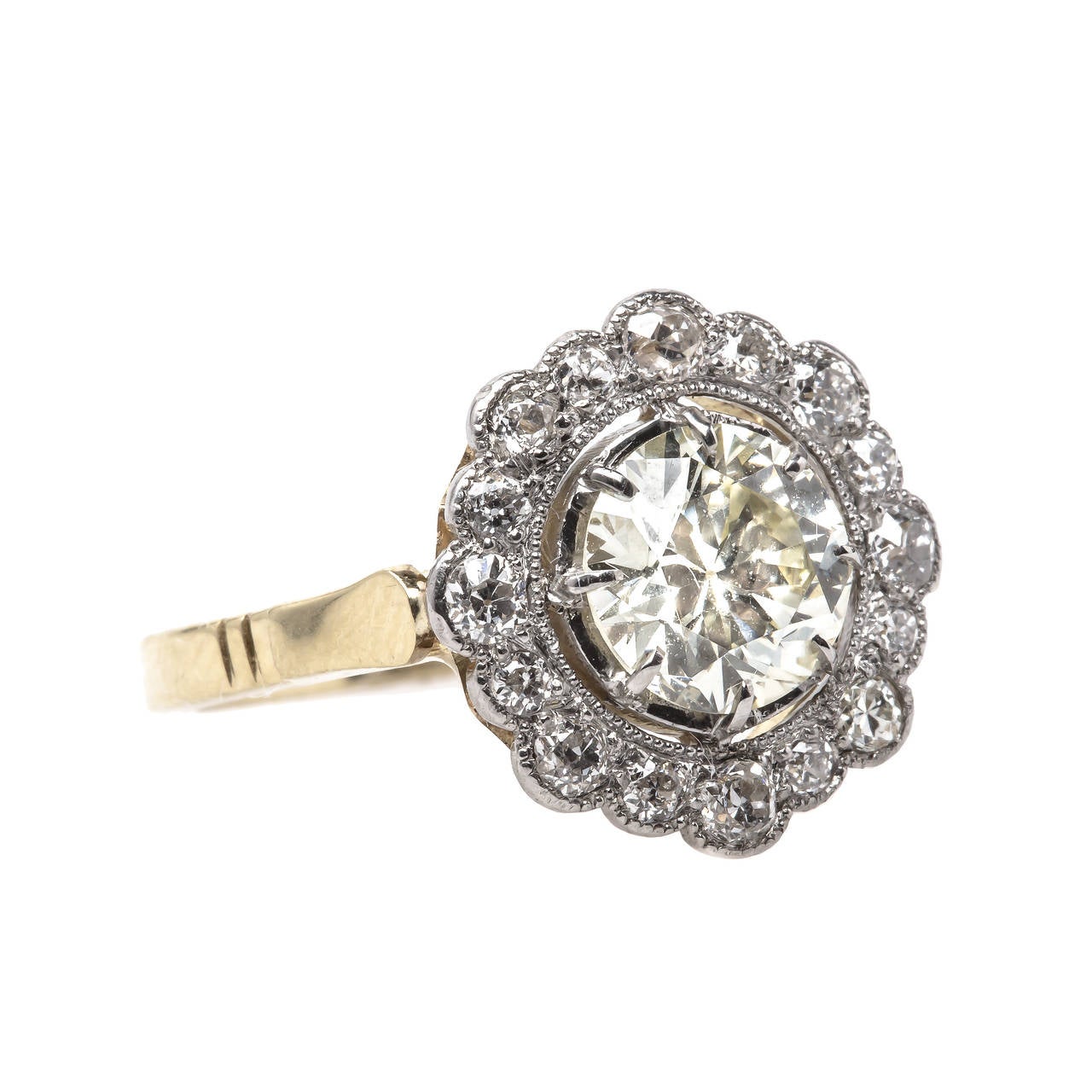Scarborough is a show stopping Edwardian era platinum topped 18k yellow gold ring stamped with French Hallmarks. The center 1.59 carat Transitional Brilliant diamond is accompanied with an EGL certificate stating the diamond is O-P color and VS1