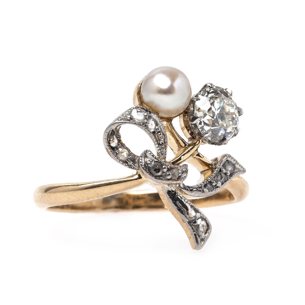 Chancery Lane is a romantic authentic Edwardian era (circa 1910) platinum topped 18k yellow gold ring featuring a classic diamond and pearl combination. It features a 0.41ct EGL certified Old European Cut diamond graded I color and VS2 clarity