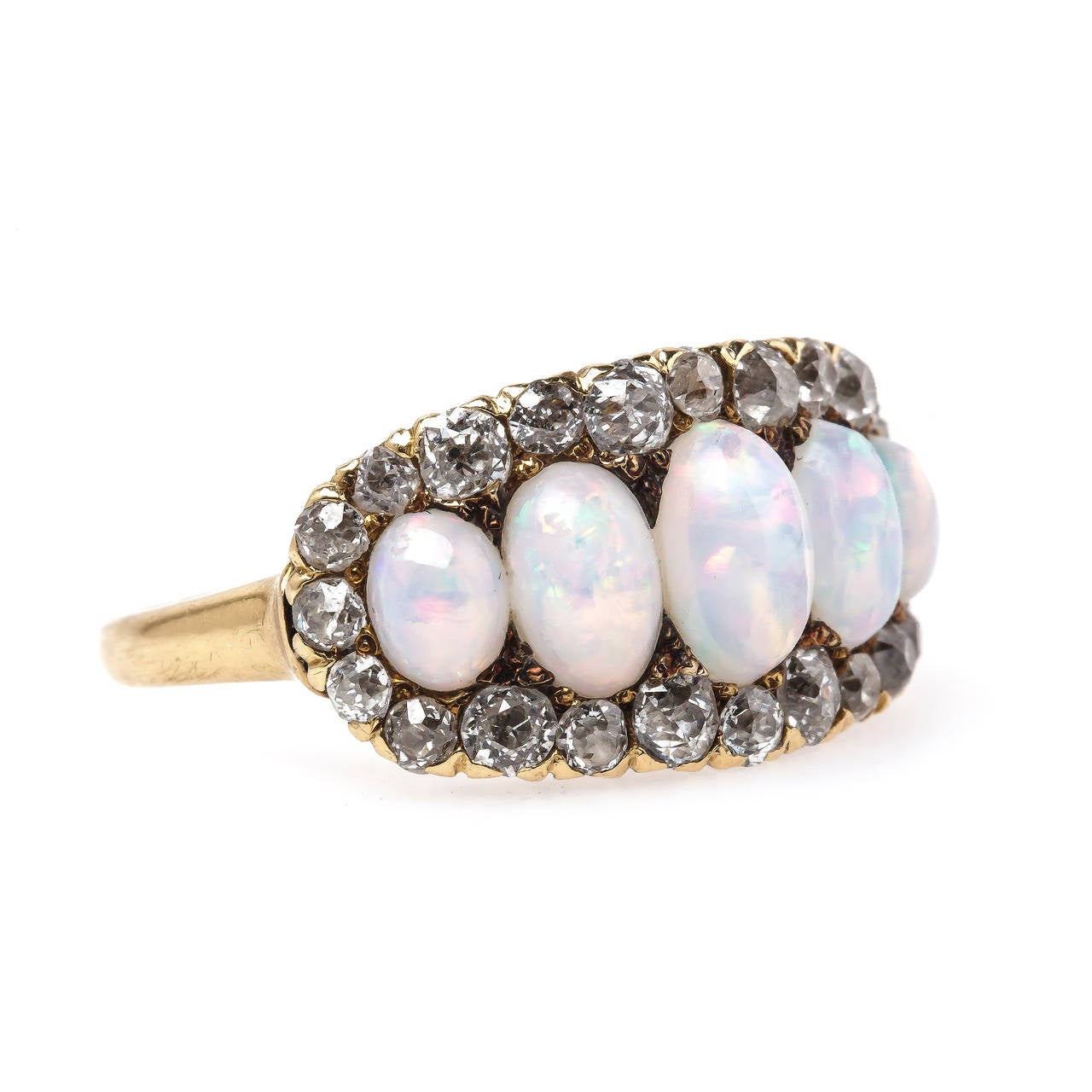 Coachella is a favorite here at T&H! The whimsical authentic Victorian era (circa 1890) 18k yellow gold ring features five beautiful oval opals gauged from 7.10mm x 4.6mm to 4.7mm x 3.5mm displaying a beautiful rainbow play of color in each. The