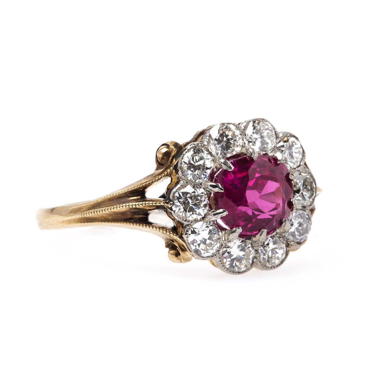 Lanesboro is a spectacular authentic Edwardian era (circa 1910) platinum topped 14k yellow gold ring complete with a T&H custom 14k yellow gold shank. The ring centers a ten-prong set oval natural ruby accompanied with a Guild Laboratories