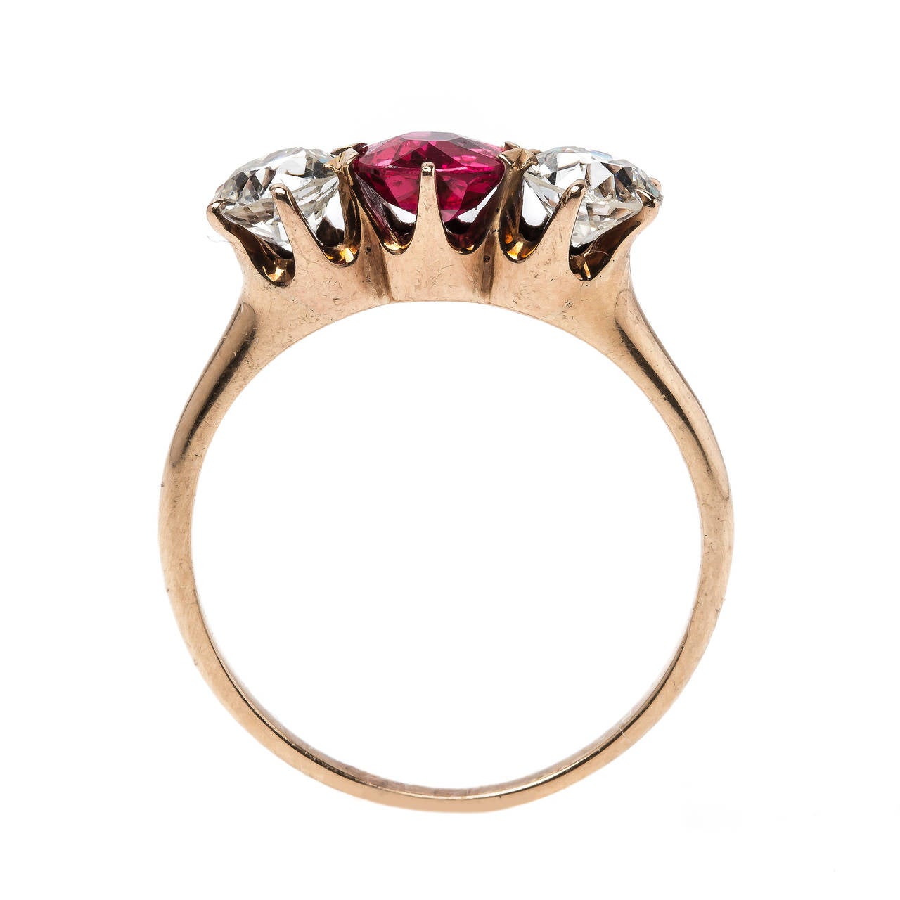 Sedona is a spectacular example of Victorian craftsmanship (circa 1870) designed in 14k rose gold featuring a stunning three stone combination. An intensely saturated orange-red round faceted spinel accompanied with a Guild Laboratories certificate