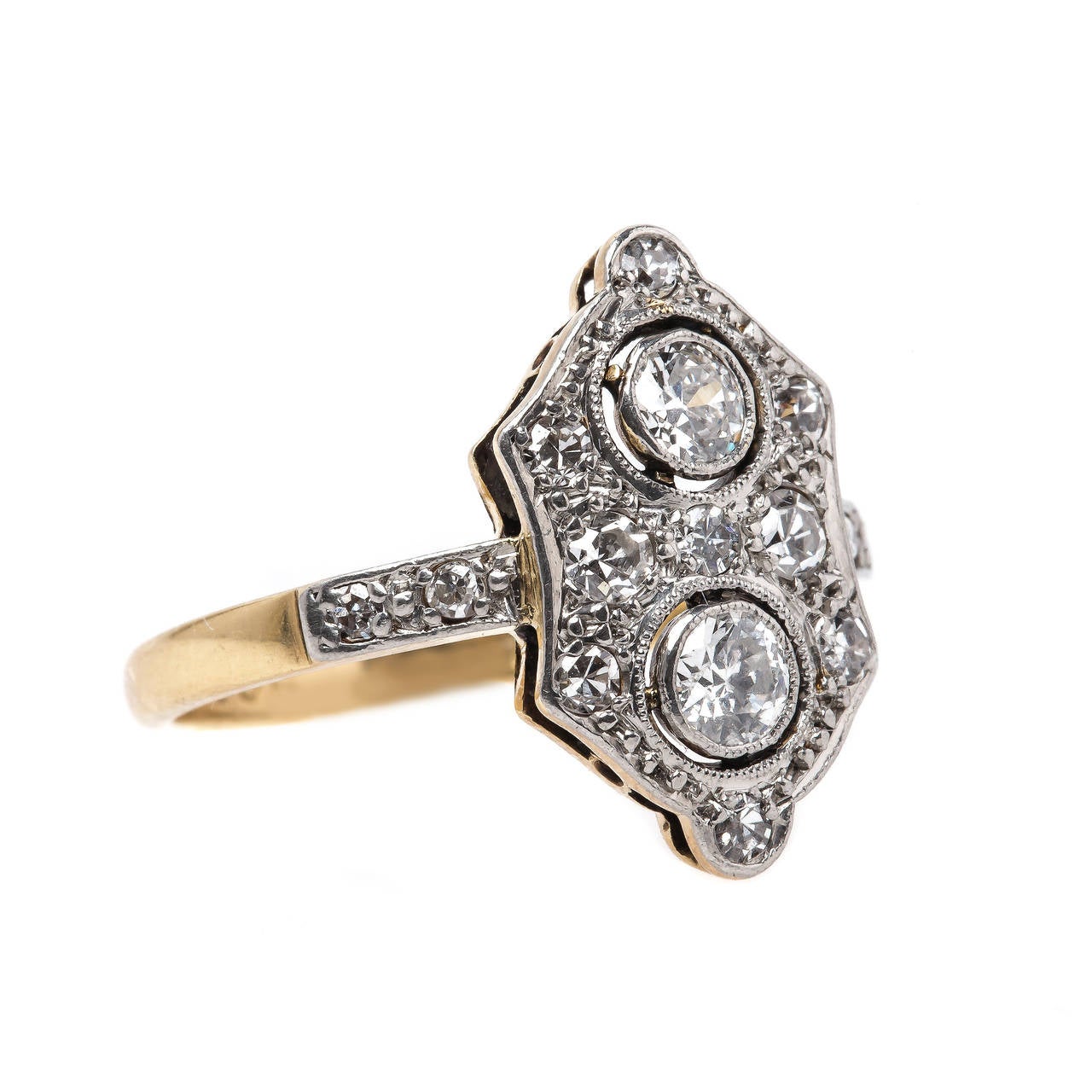 Burnt Oak is an exceptional authentic Edwardian era (circa 1905) navette style platinum topped 18k yellow gold diamond ring featuring two Old European Cut diamonds designed vertically in bezel settings, gauged at approximately 0.40ct total weight,