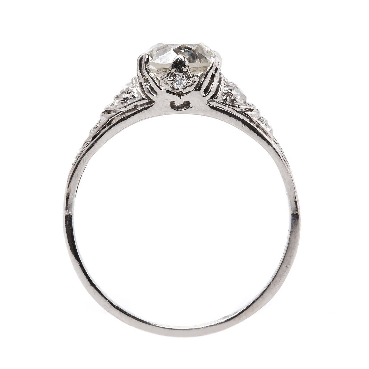 Lockhaven is a gorgeous Early Art Deco (circa 1915) platinum ring centering a six prong-set 1.42ct EGL certified Old European Cut diamond graded J color and VS1 clarity. Four Old European Cut diamonds line the shoulders of this lovely original ring