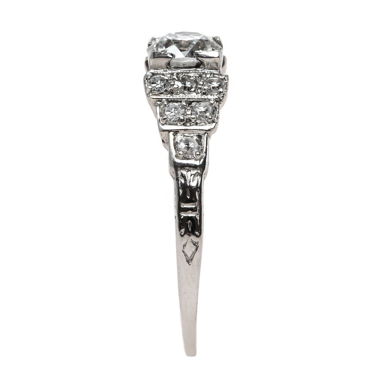 Carolwood is a classic Art Deco engagement ring (circa 1925) made from platinum centering a 0.54ct EGL certified Old European Cut diamond graded F color and VS2 clarity. The stunning center diamond is set in a crisp box setting and finished with