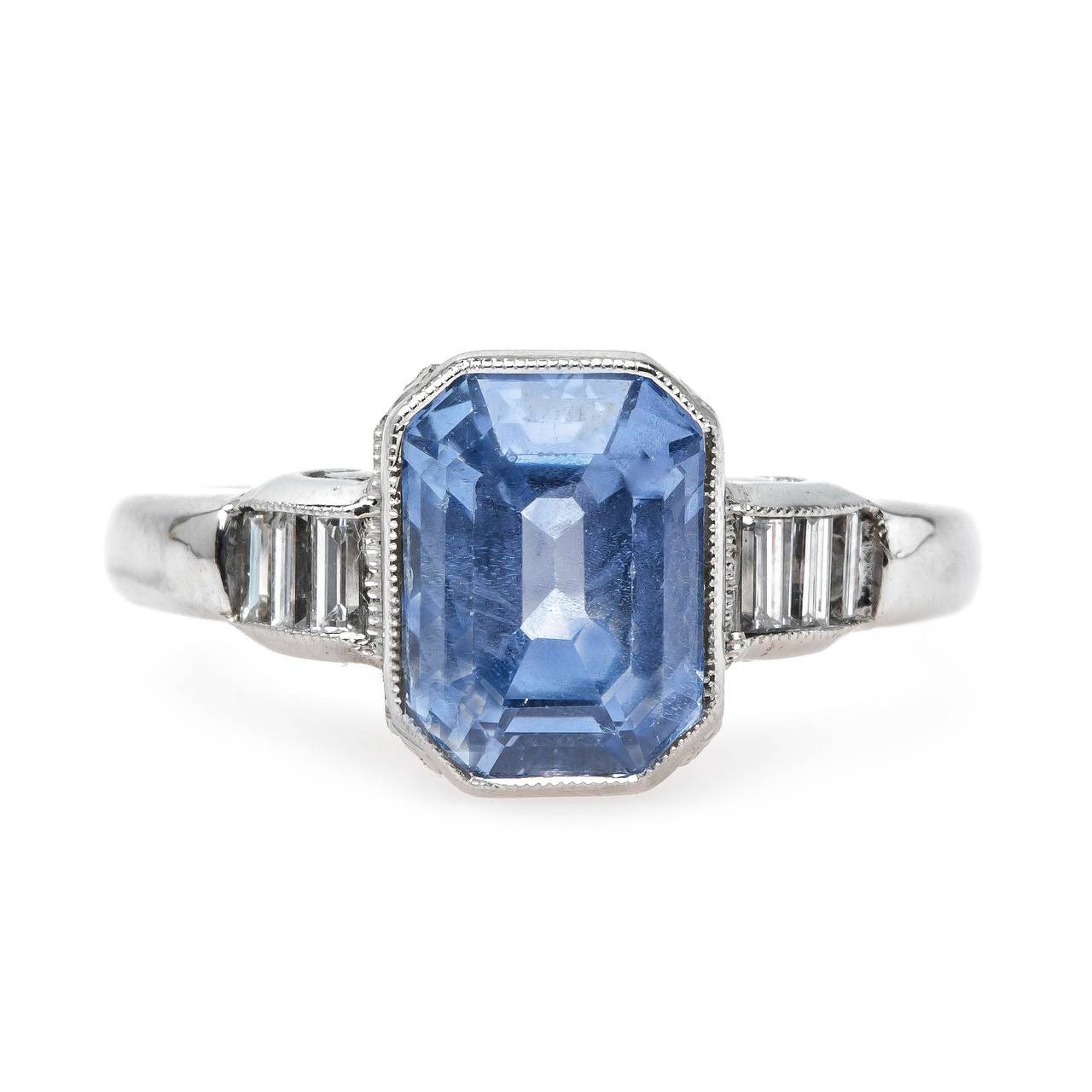 Malibu is an impressive authentic Mid Century (circa 1950) platinum ring centering a single bezel set cornflower blue 3.46ct natural sapphire accompanied with a Guild Laboratories certificate stating the sapphire is unheated with Ceylon origin.